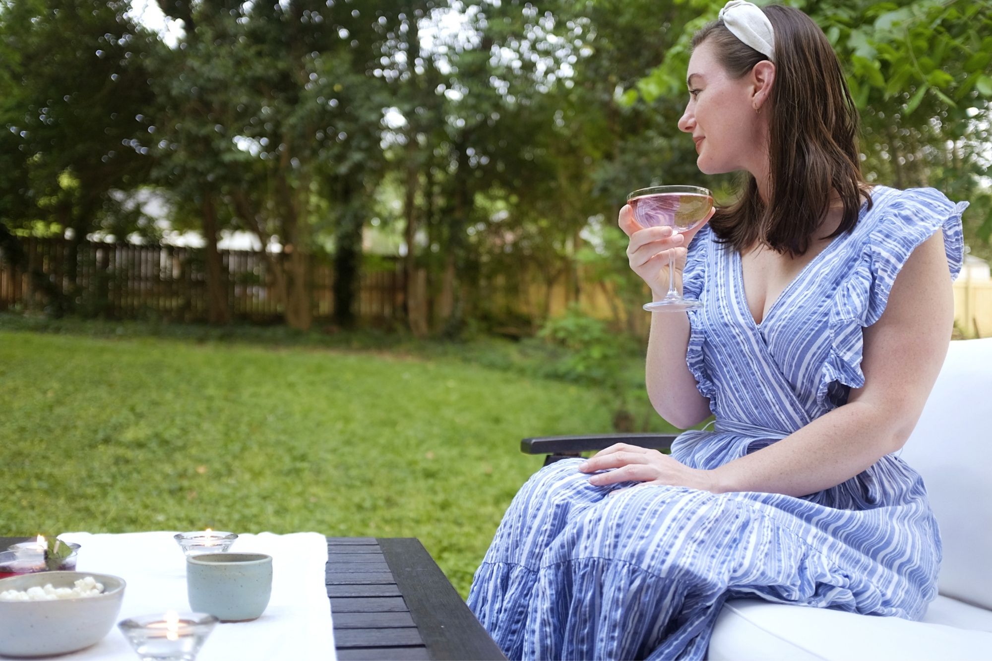 Alyssa sits outdoors with a cocktail