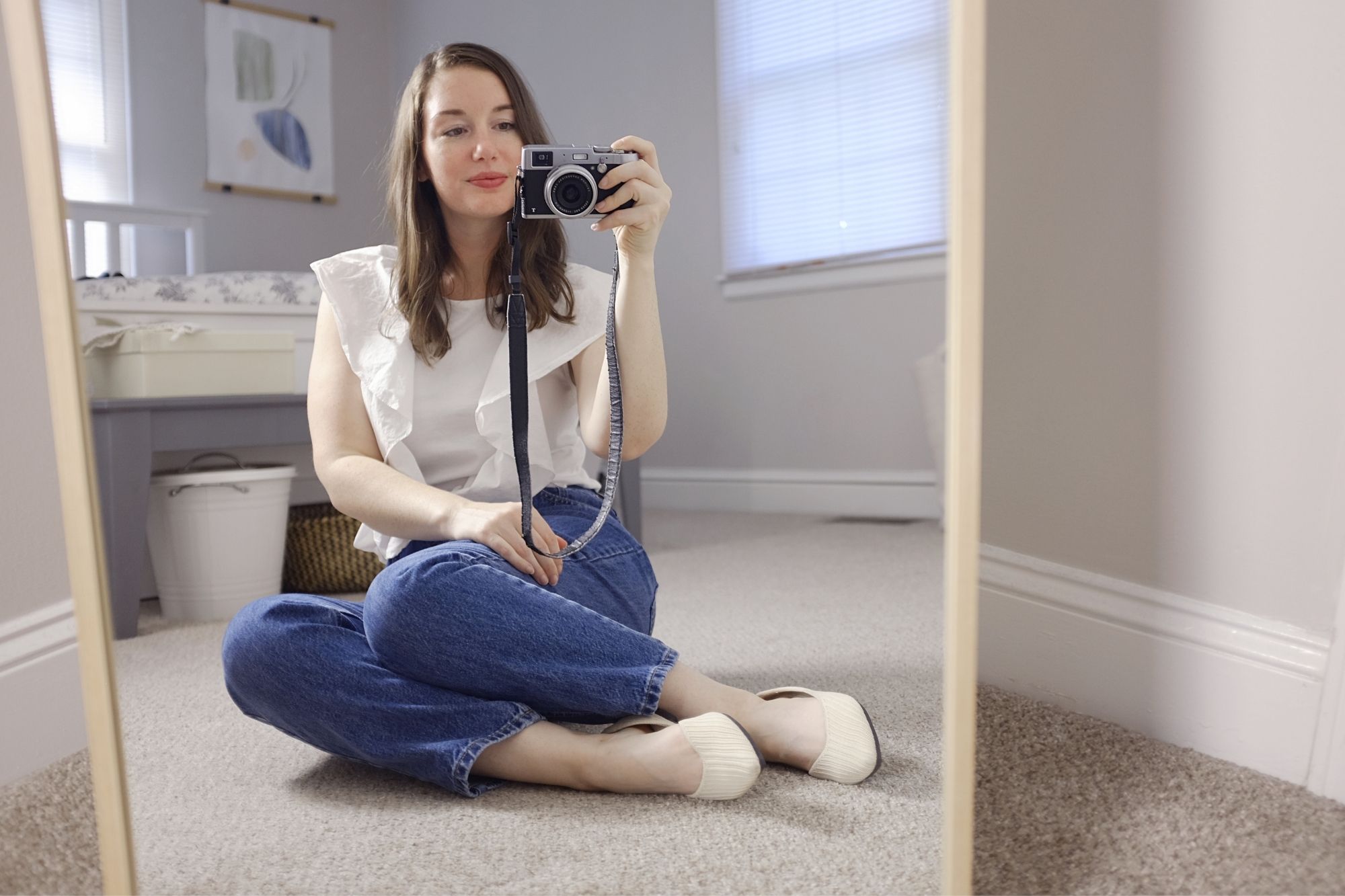 Alyssa sits in front of the mirror wearing the flats