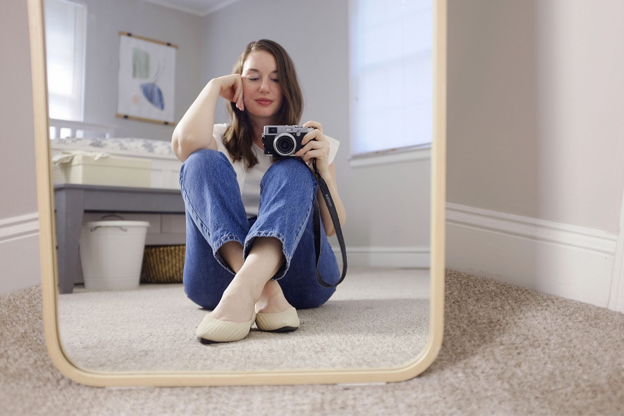 Alyssa sits in front of the mirror wearing the Melia flats