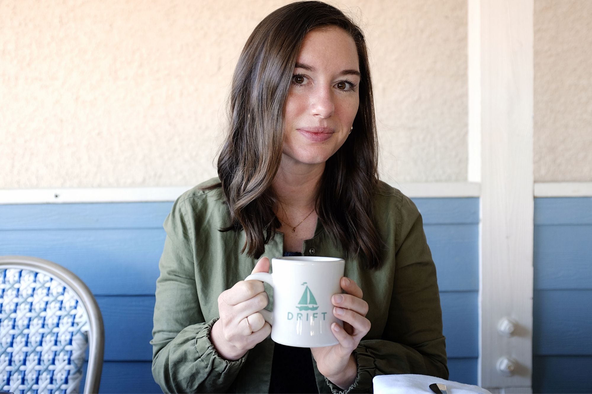 Alyssa holds the Drift Cafe mug