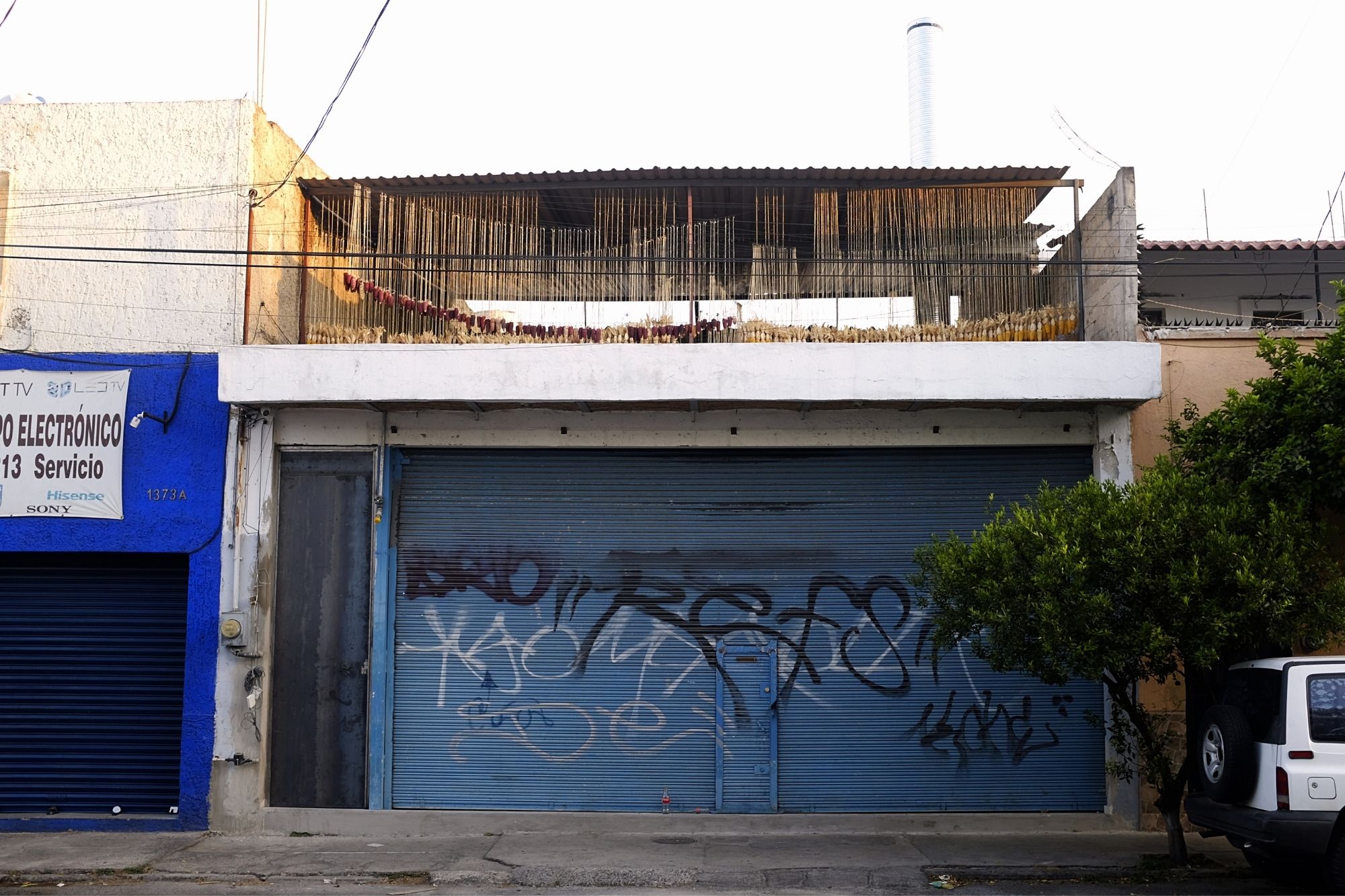 Corn can be seen drying on a rooftop