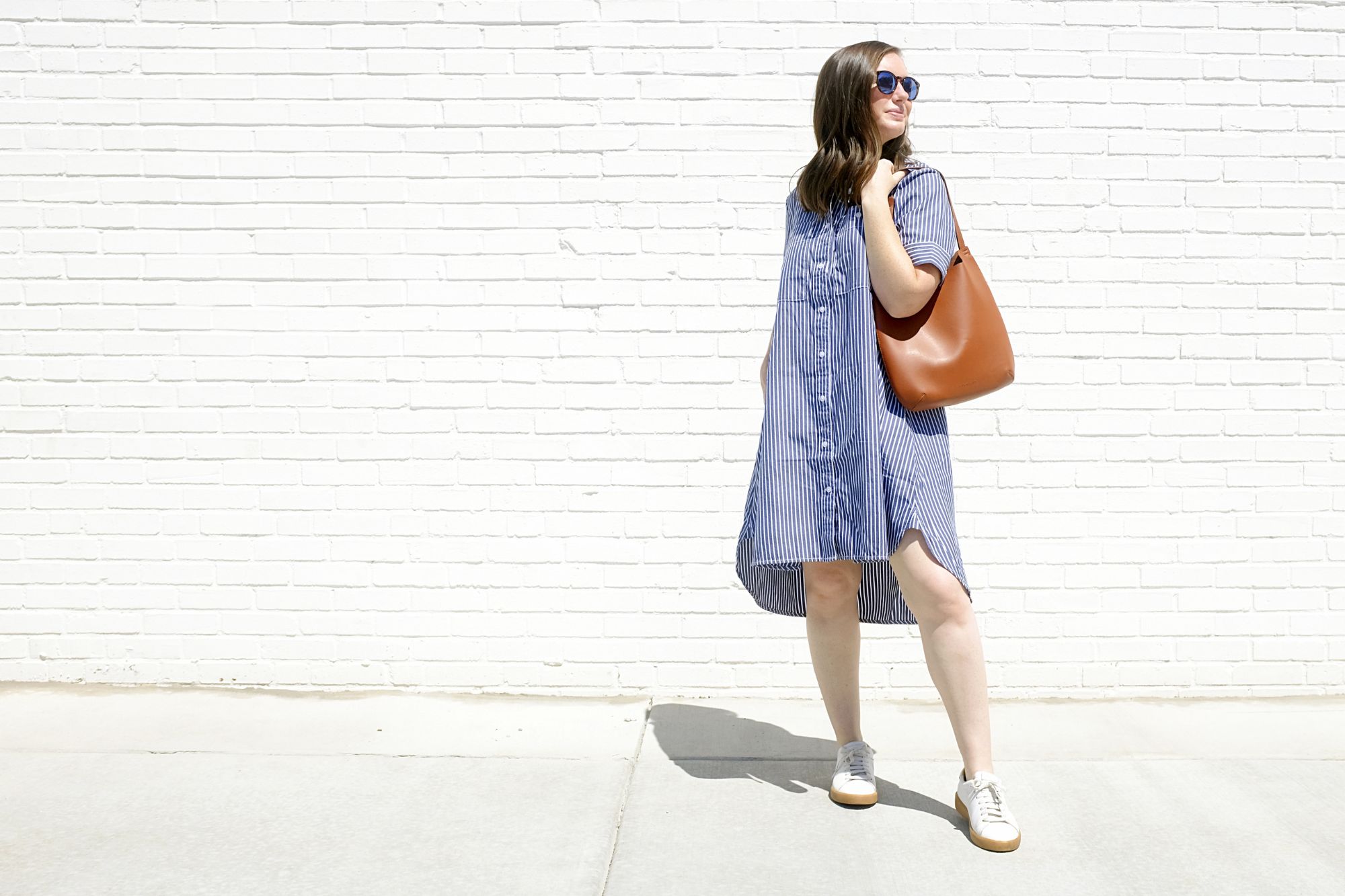 Alyssa stands holding the Cactus Leather bag