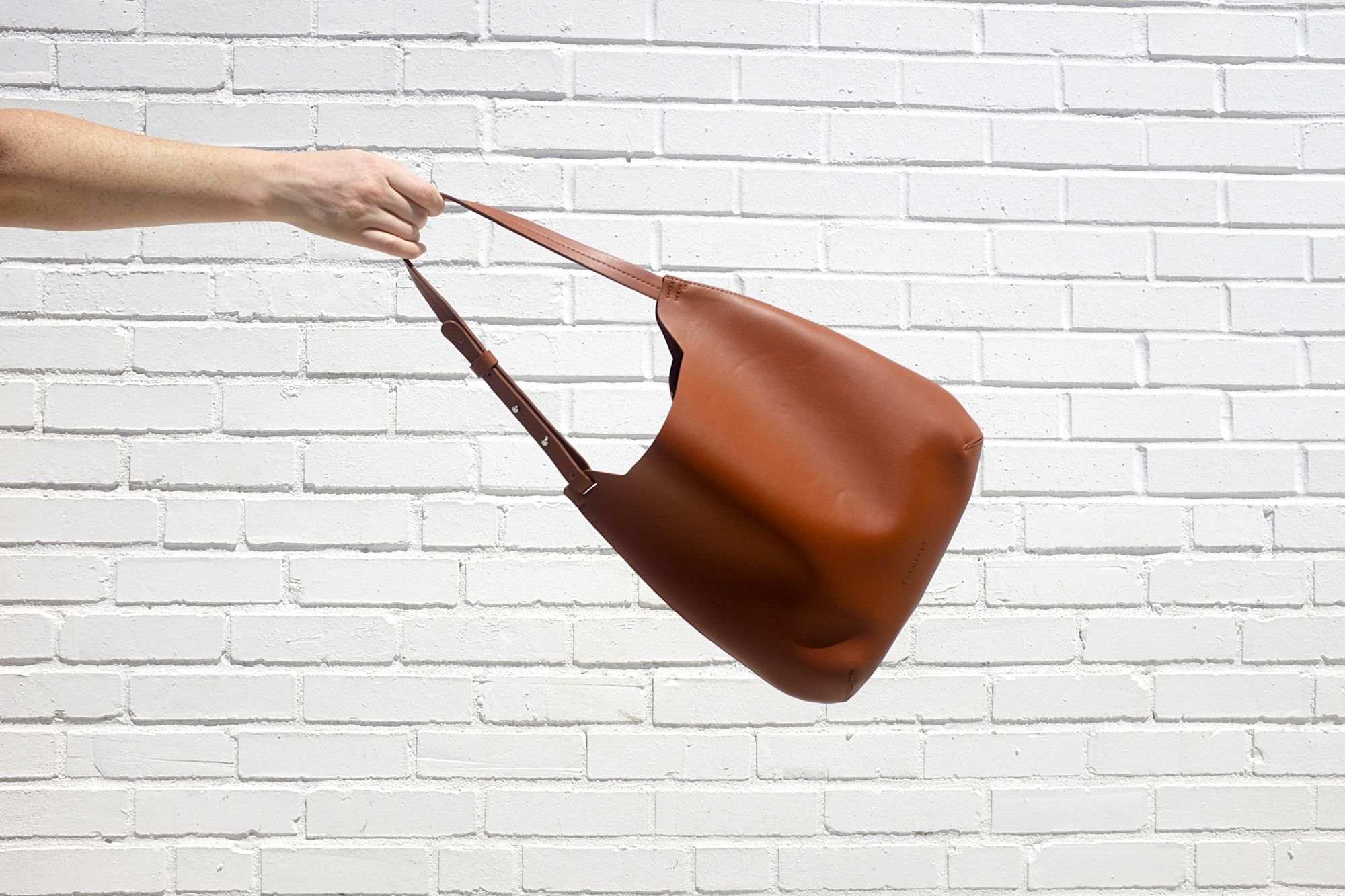 The Cactus Leather Hobo is swung in the air