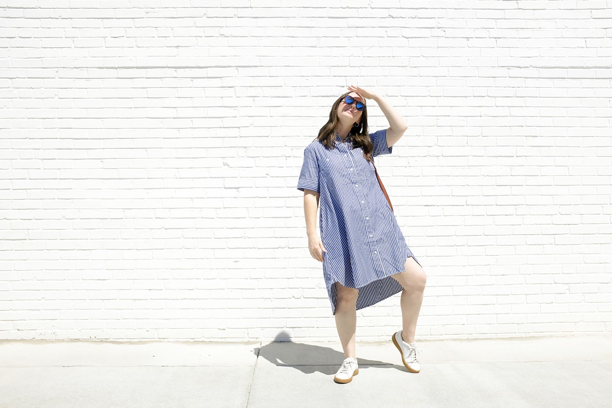 Alyssa wears the daytripper shirtdress and looks to the sun