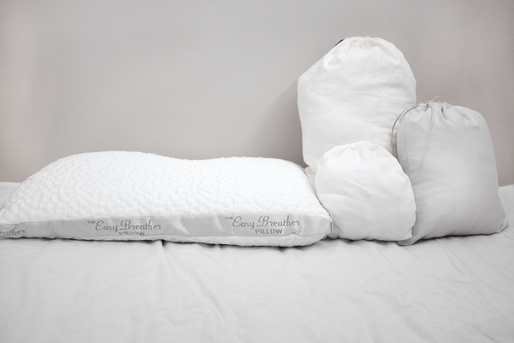 The Easy Breather Pillow next to bags of extra stuffing