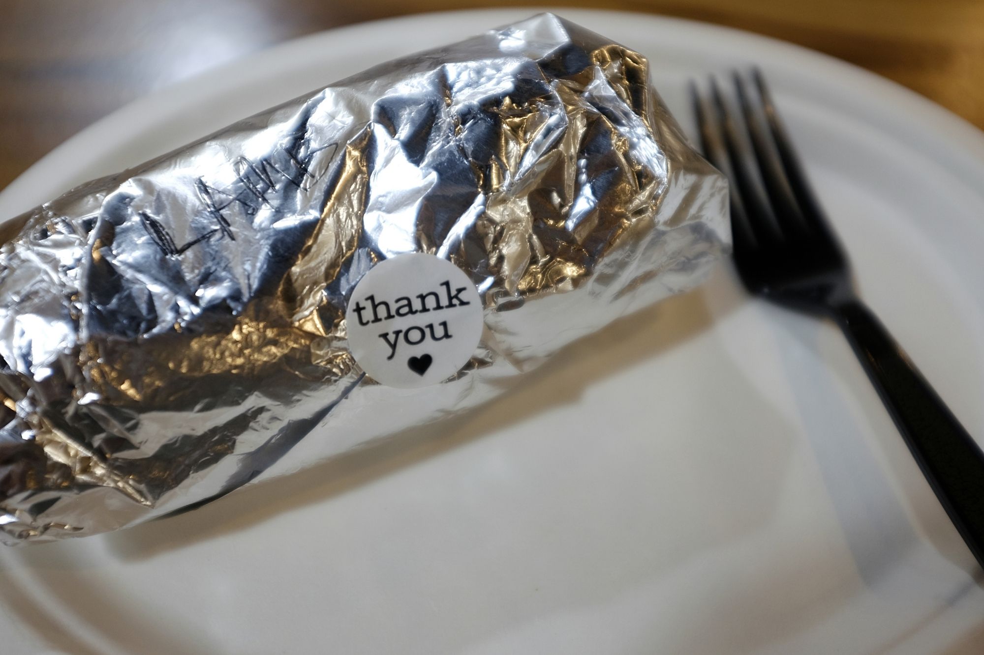 Aluminum foil wrap with a sticker that reads Thank You
