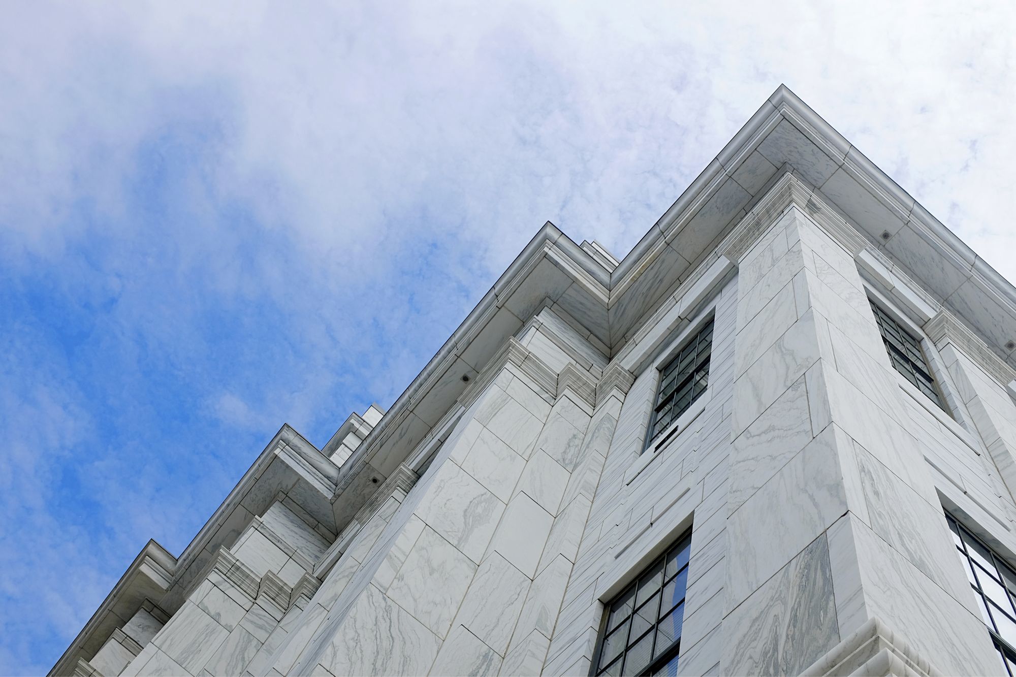 View of a building from below in Albany, with the blue sky in the background