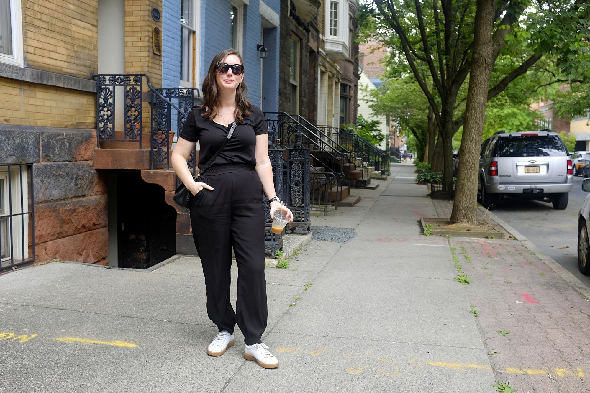 Alyssa holds a coffee in the street in Albany