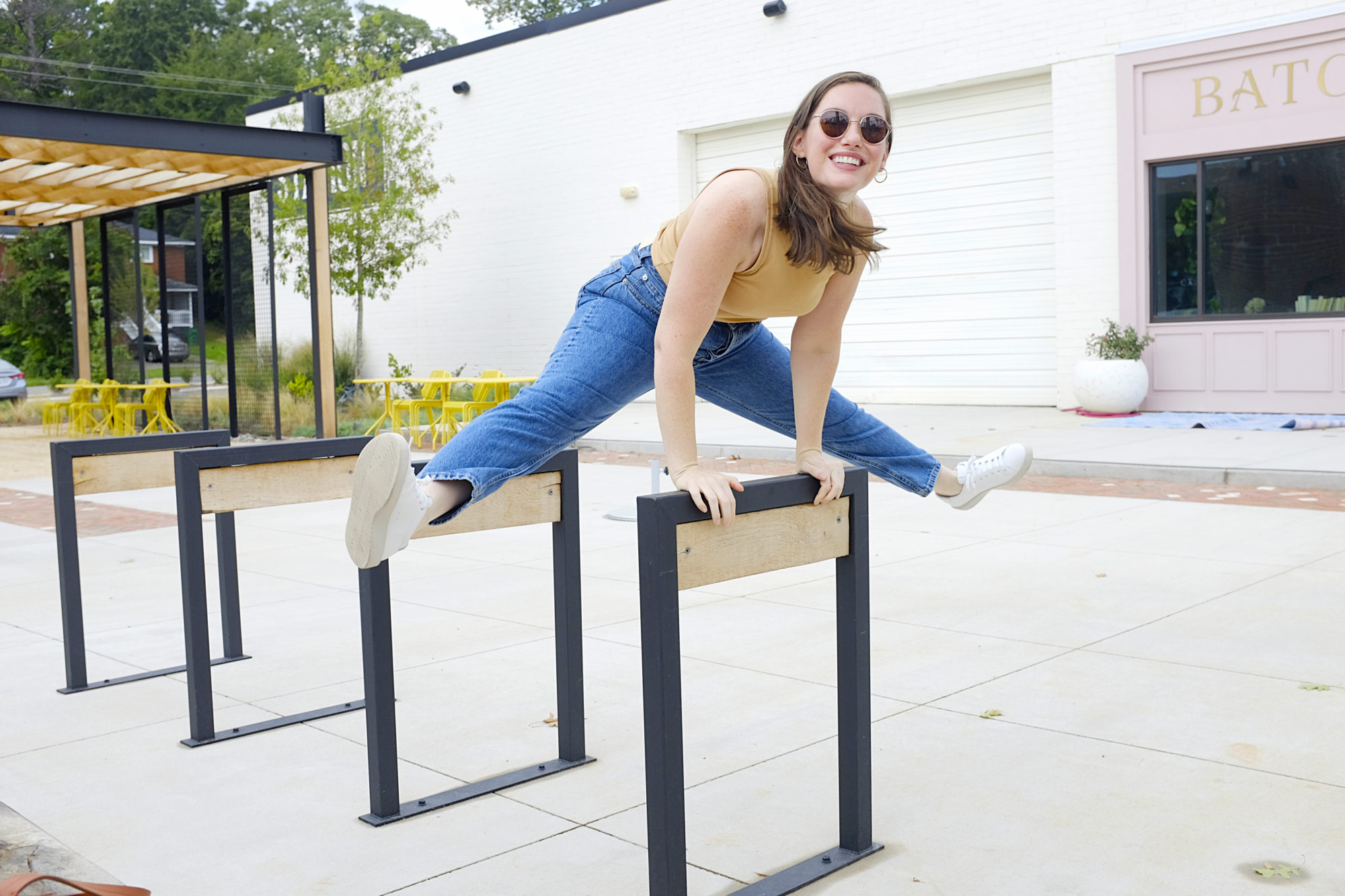 Alyssa wears the Releather Tennis Shoe and jumps over a bike docking station