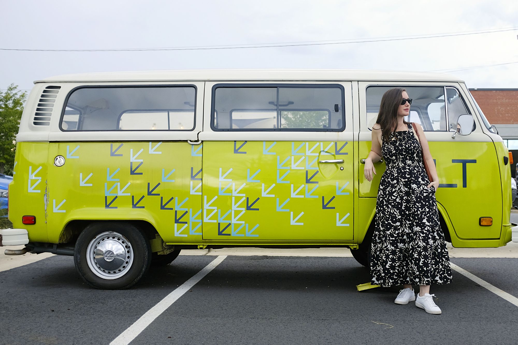 Alyssa stands in front of a VW wearing The Smock Dress Floral