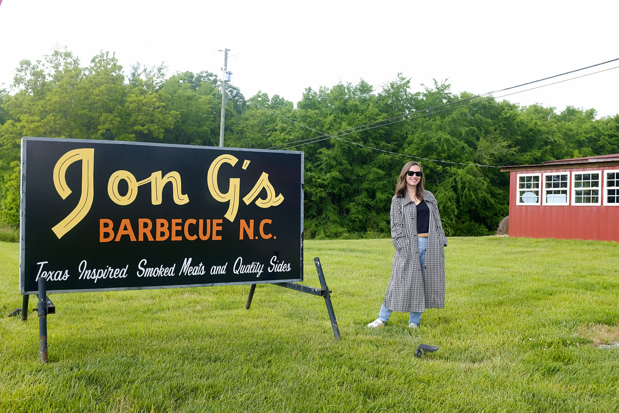 Alyssa stands in front of the Jon G's sign