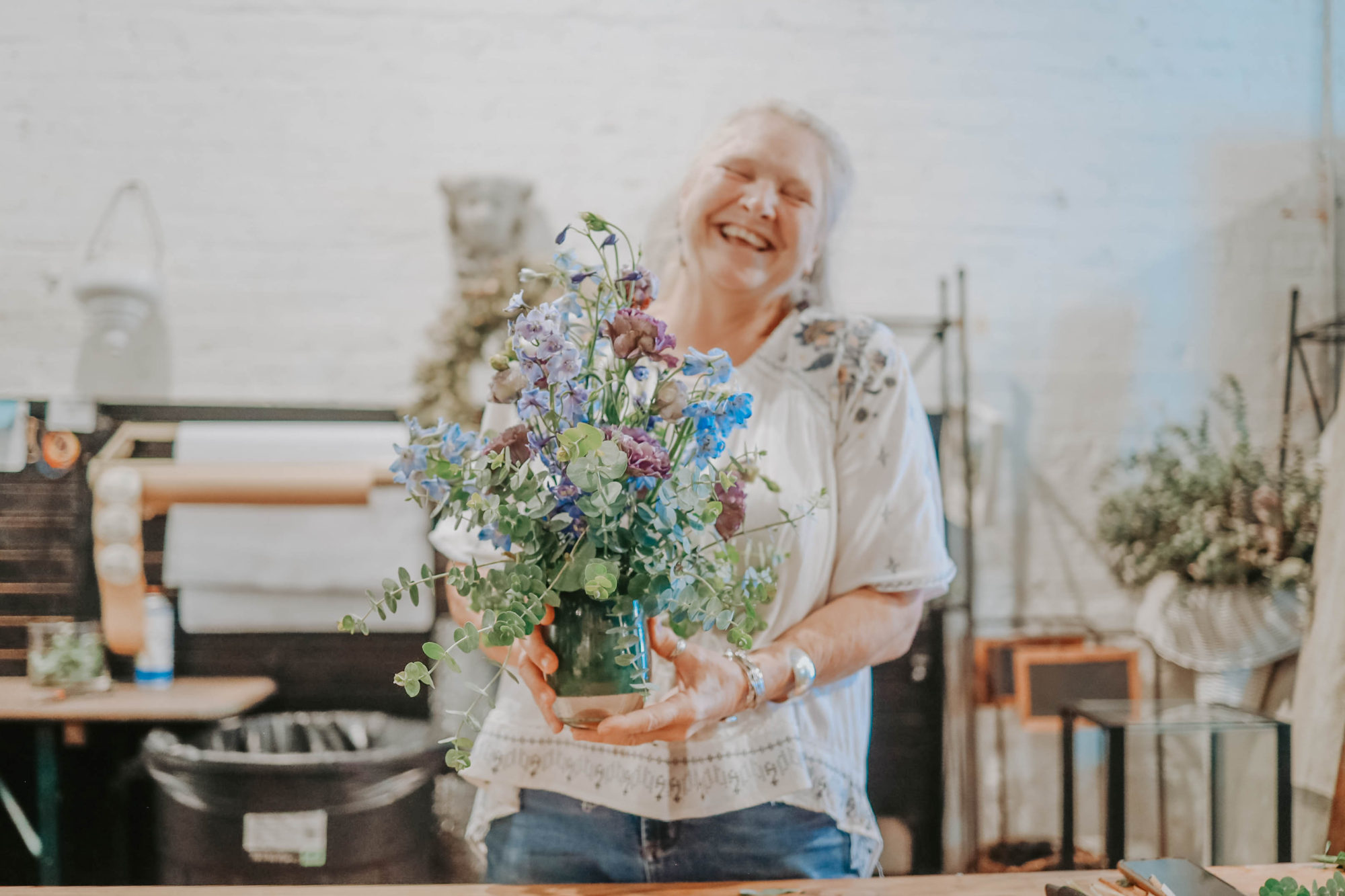 Katherine holds a stunning floral arrangement