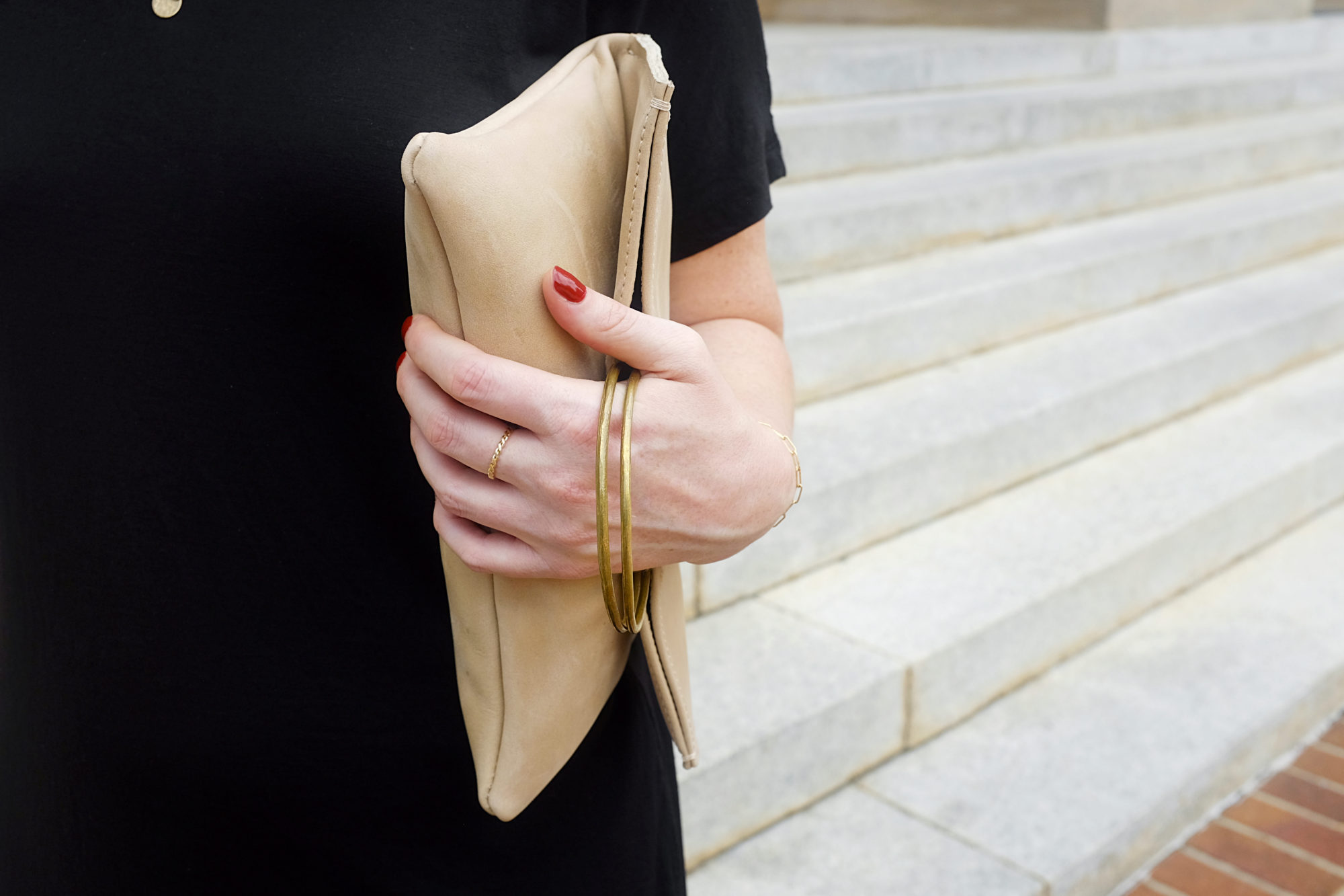 A close up of Alyssa holding the Nyala Foldover Clutch