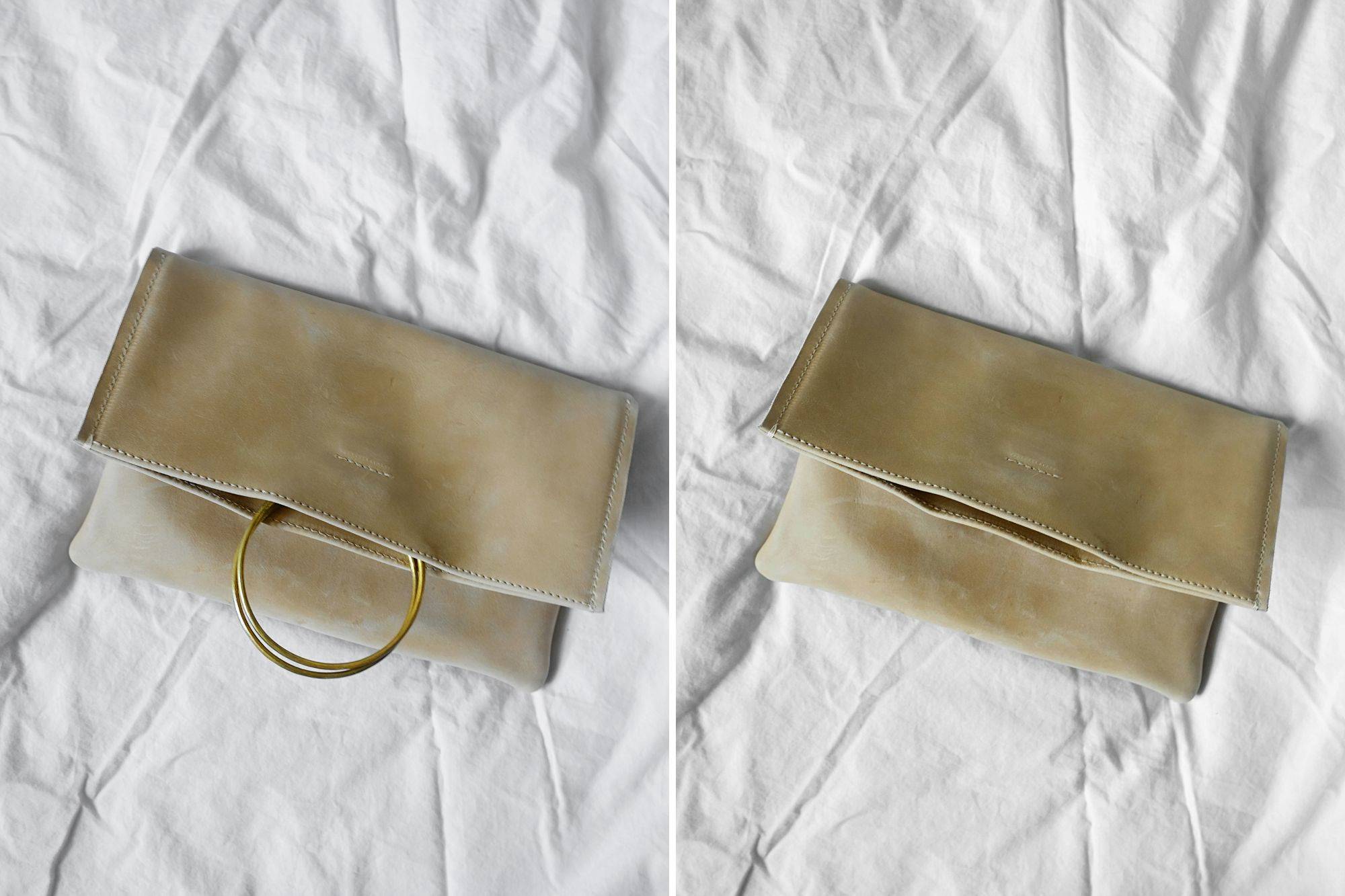 The Nyala Foldover Clutch folded over with the ring handles in and out of the bag