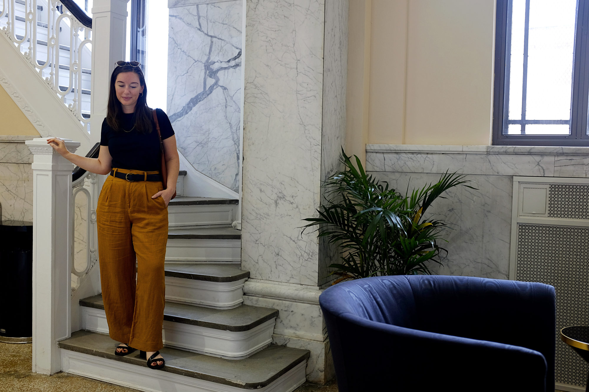 Alyssa stands on the stairs inside The Liberty Trust