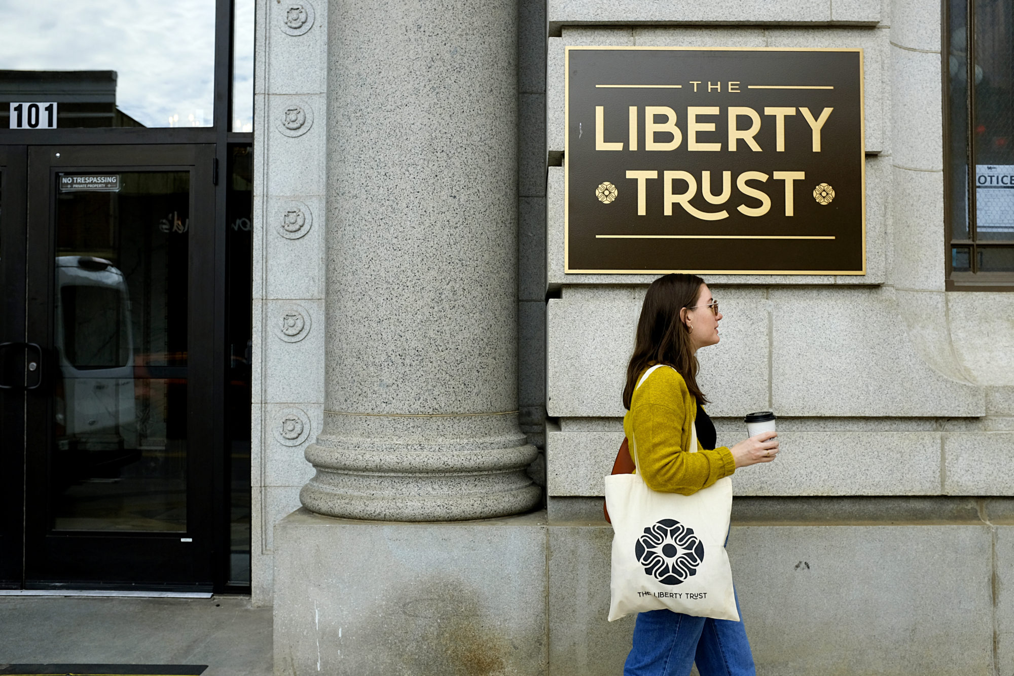 Alyssa walks in front of The Liberty Trust