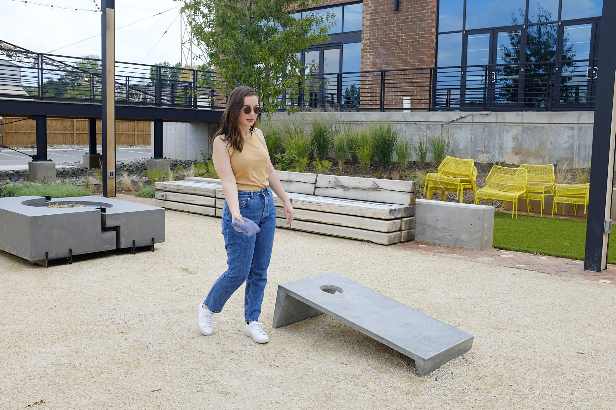 Alyssa wears The Organic Cotton Cutaway Tank and plays cornhole