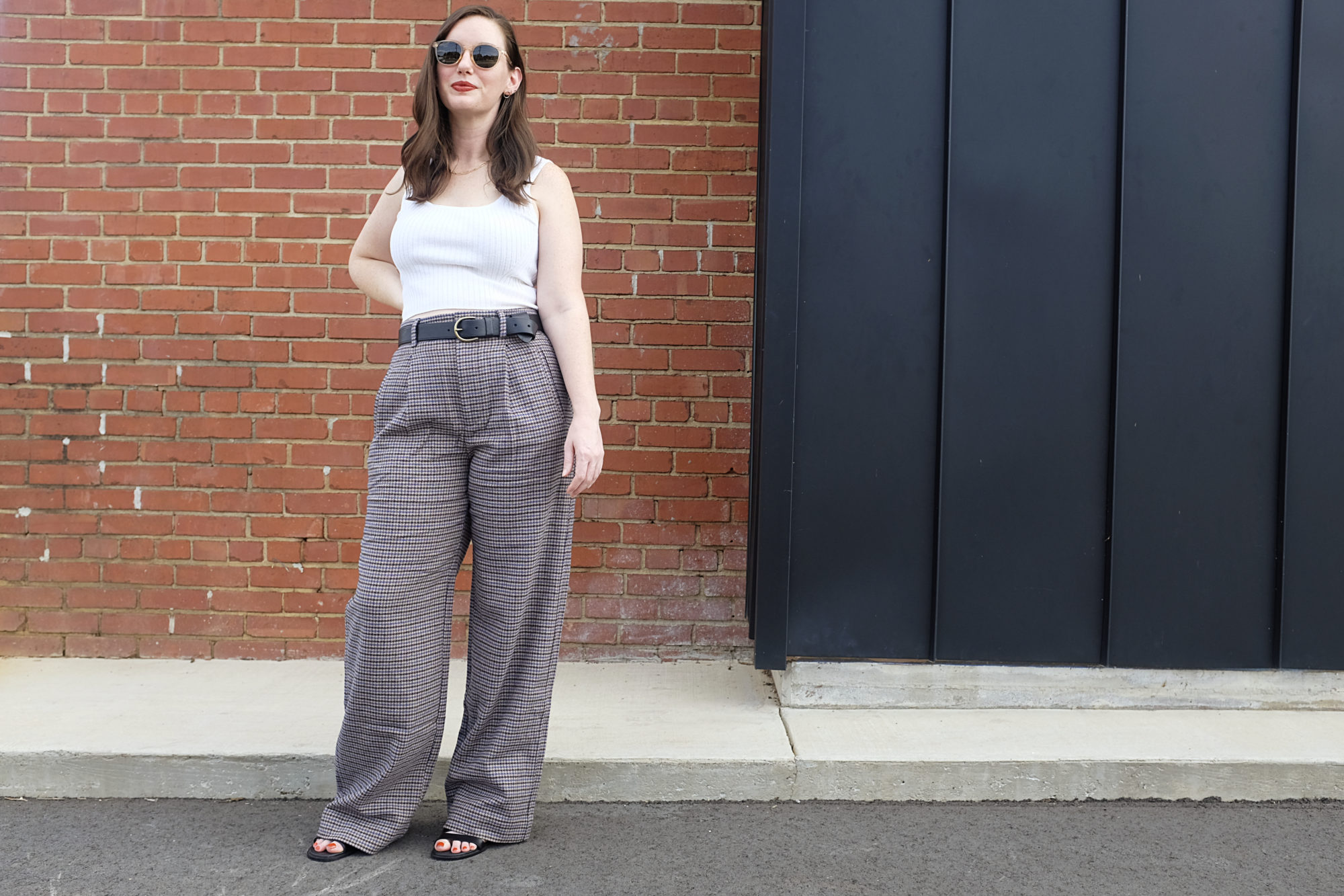 Alyssa wears The ReWool Way-High Drape Pant in front of a brick wall