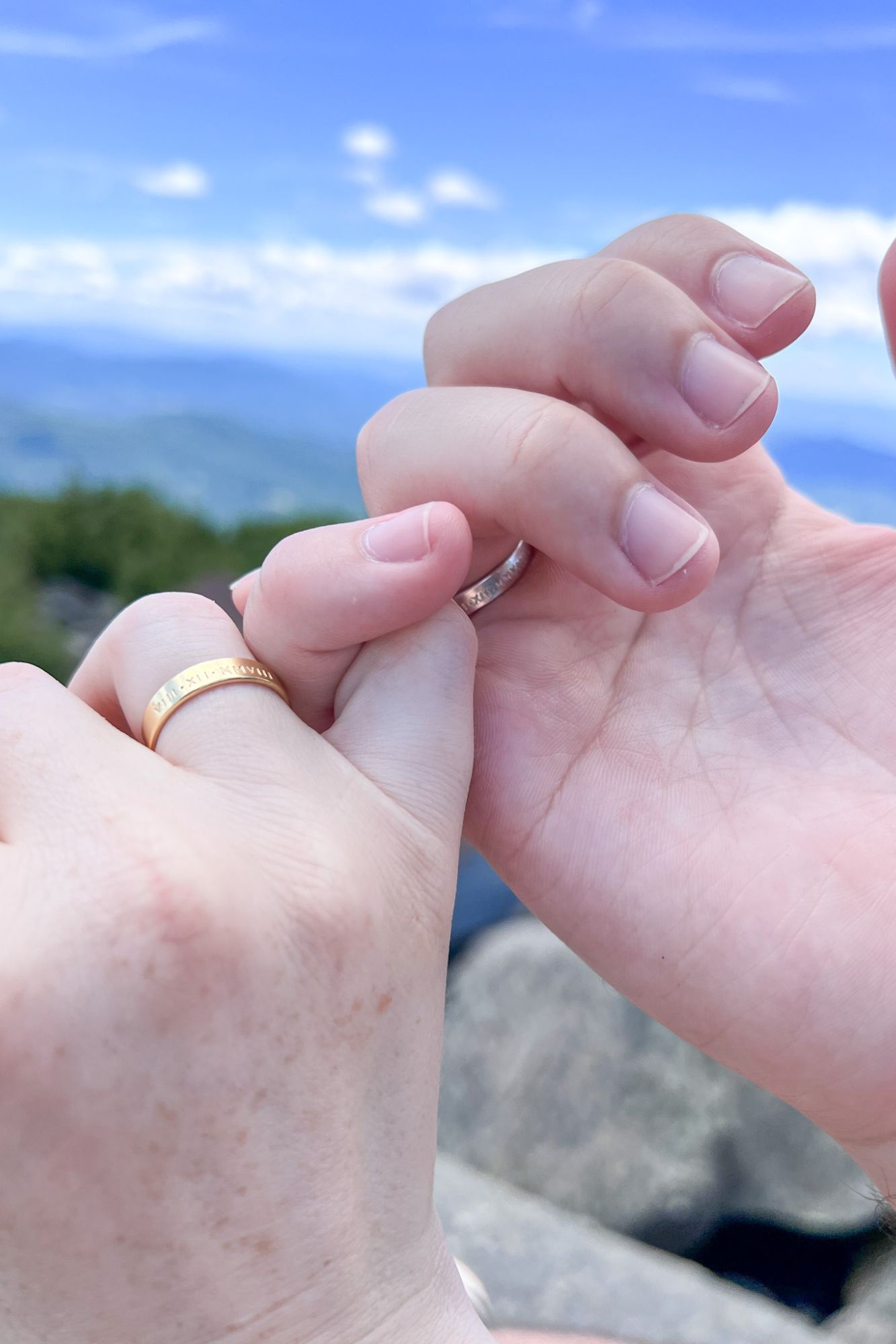 Alyssa and Michael pinky promise while wearing the Meuse Band