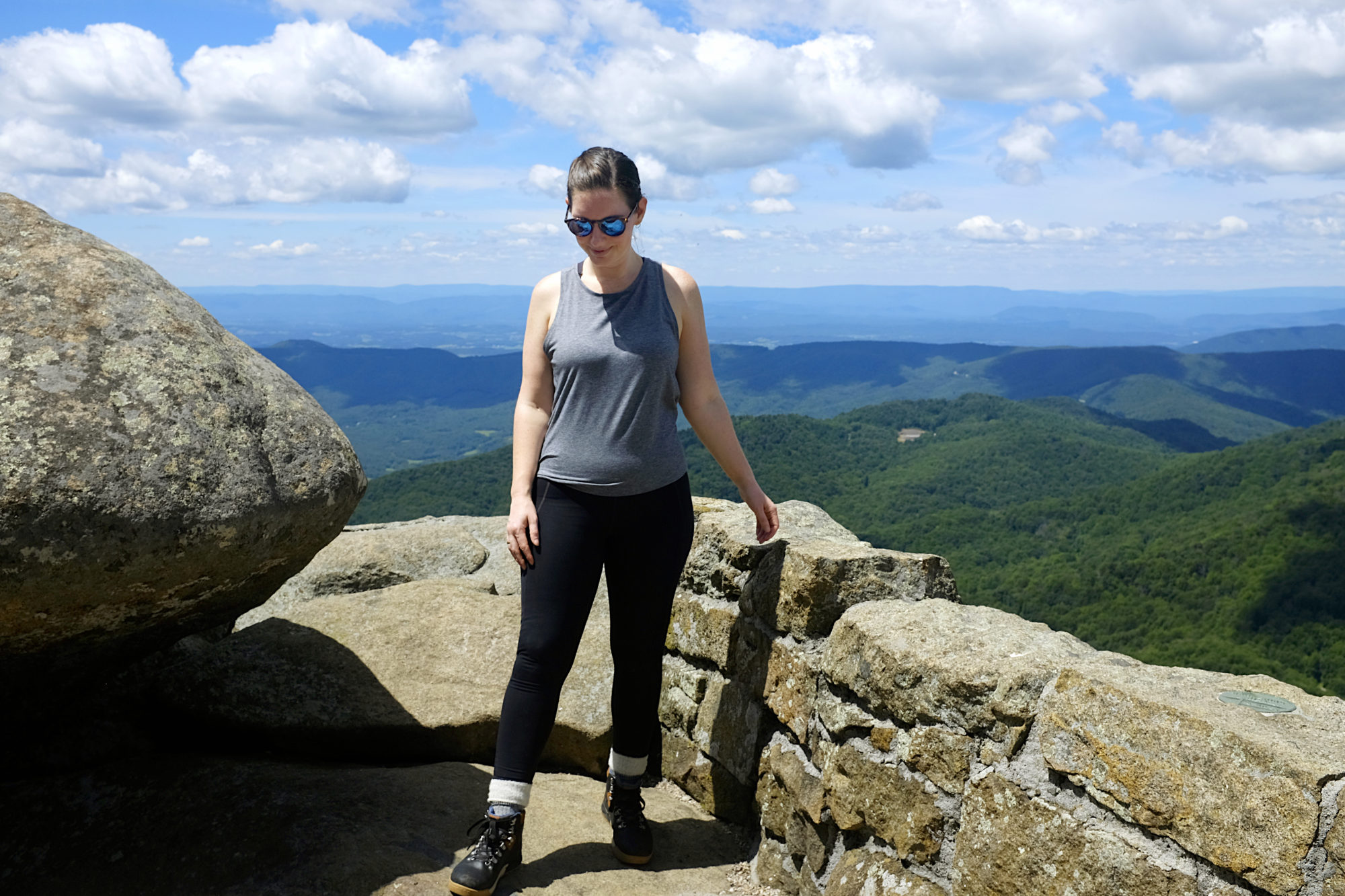 Alyssa wears athletic gear and hiking boots