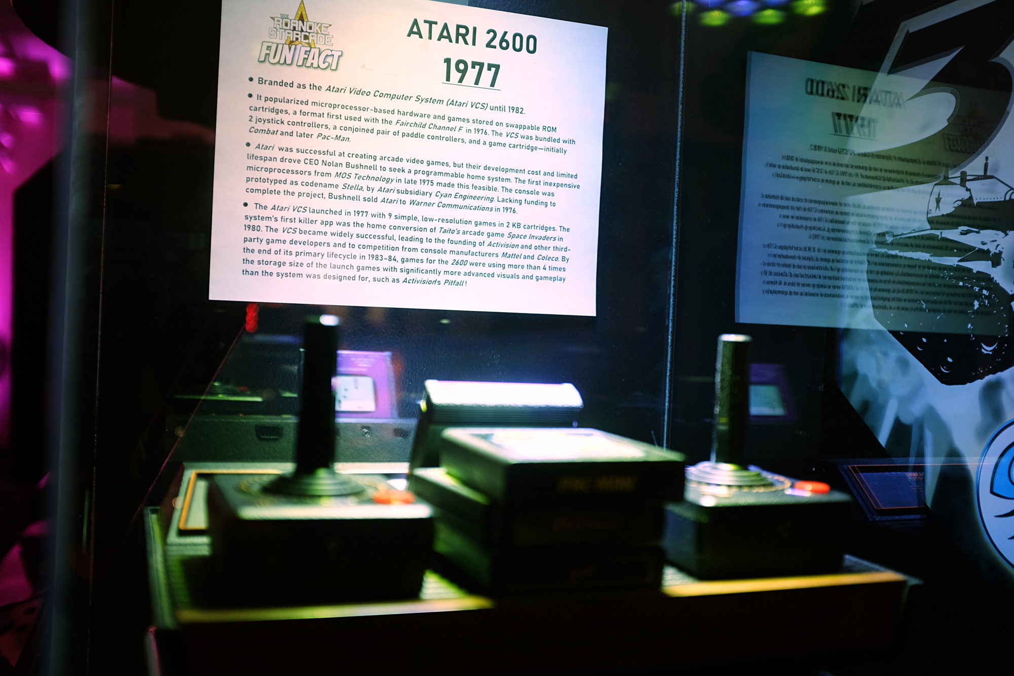 Atari controller and games in a museum case