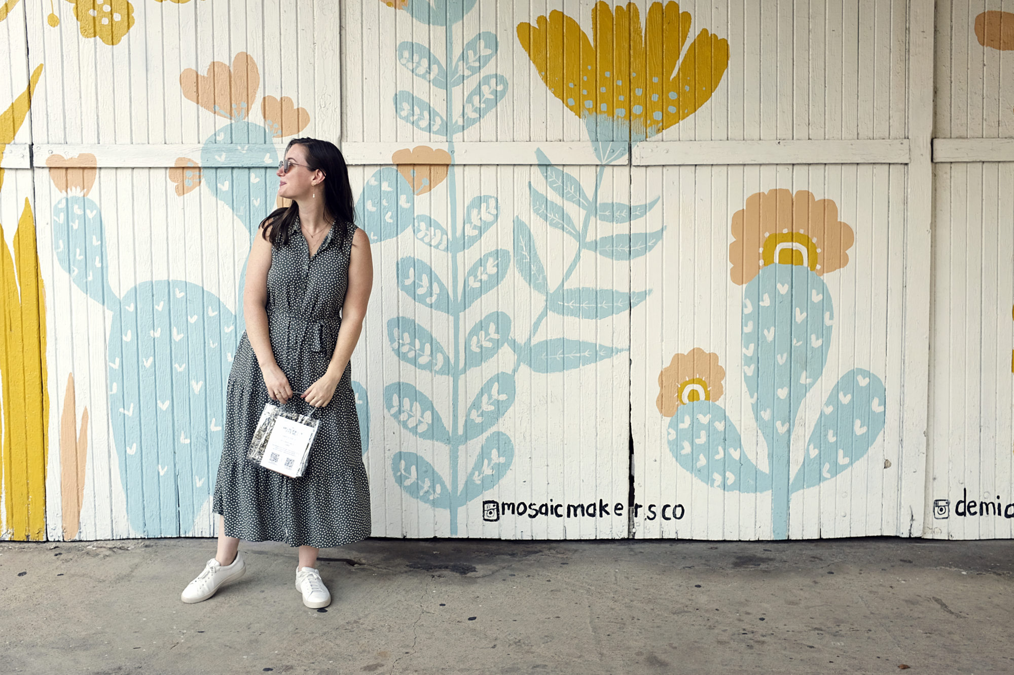 Alyssa carries a shopping bag in Bishop Arts District