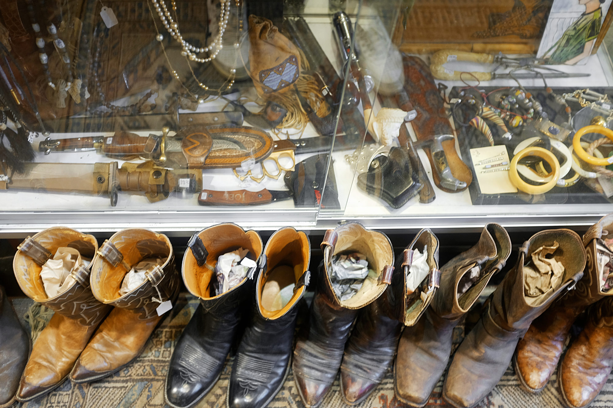 A row of cowboy boots in a thrift shop in Dallas