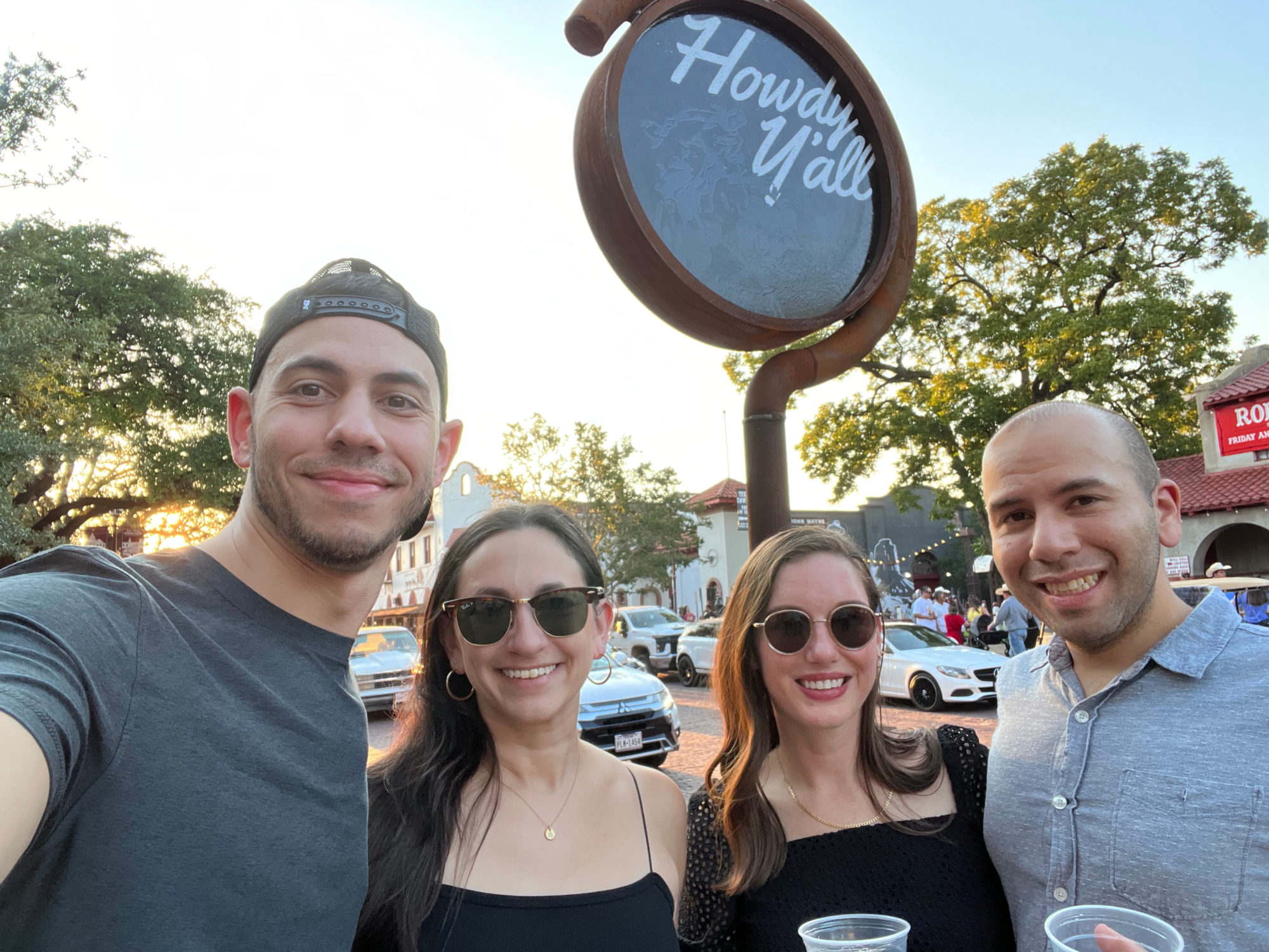 Alyssa and friends in front of a sign that says Howdy Y'all