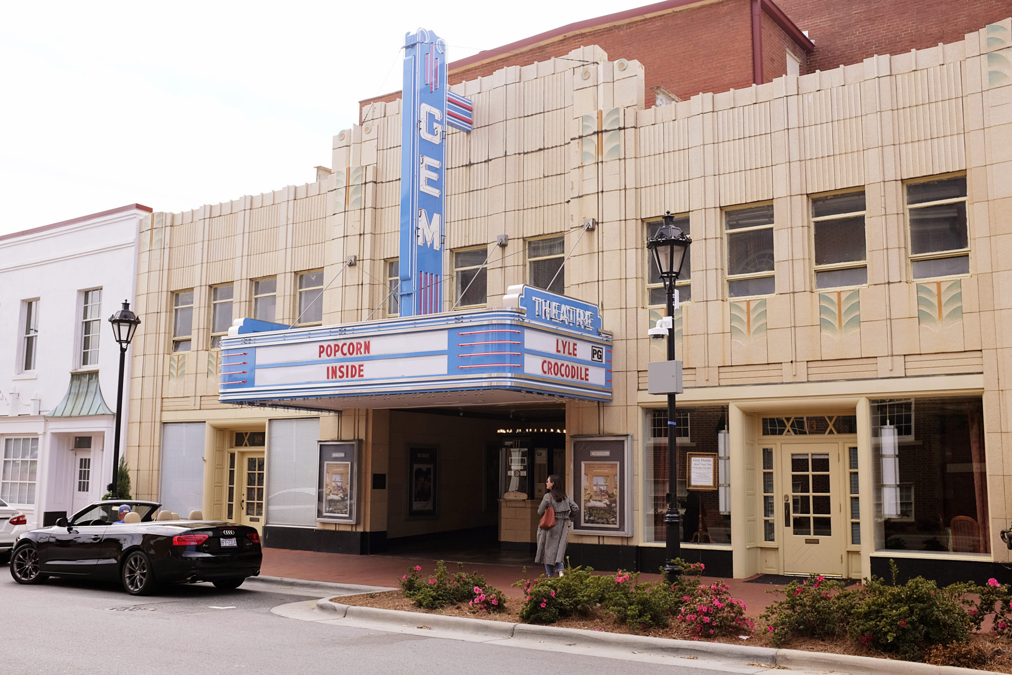 Alyssa walks below the Gem Theatre marquee