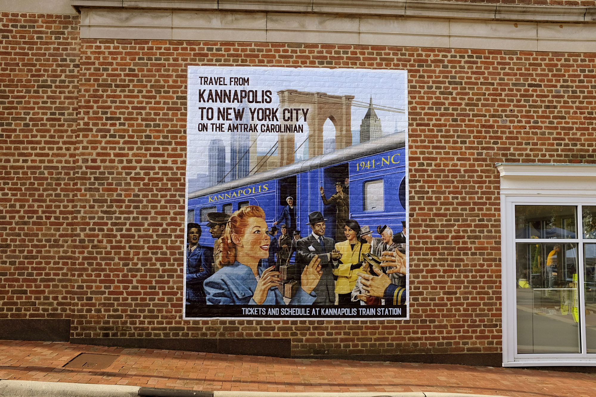 A mural advertising riding Amtrak from Kannapolis to NYC