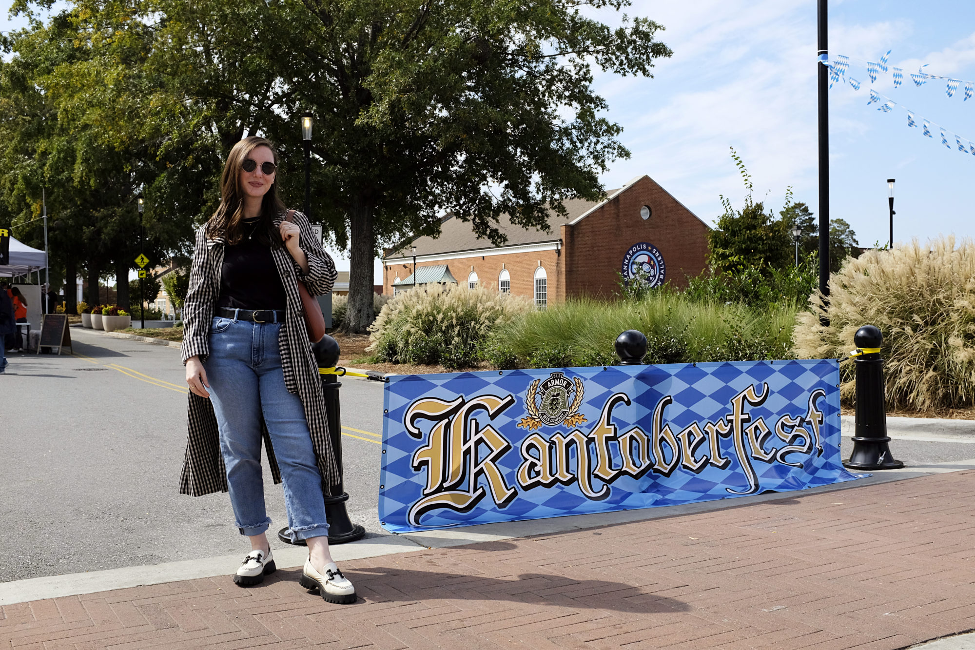 Alyssa stands next to the Kantoberfest banner