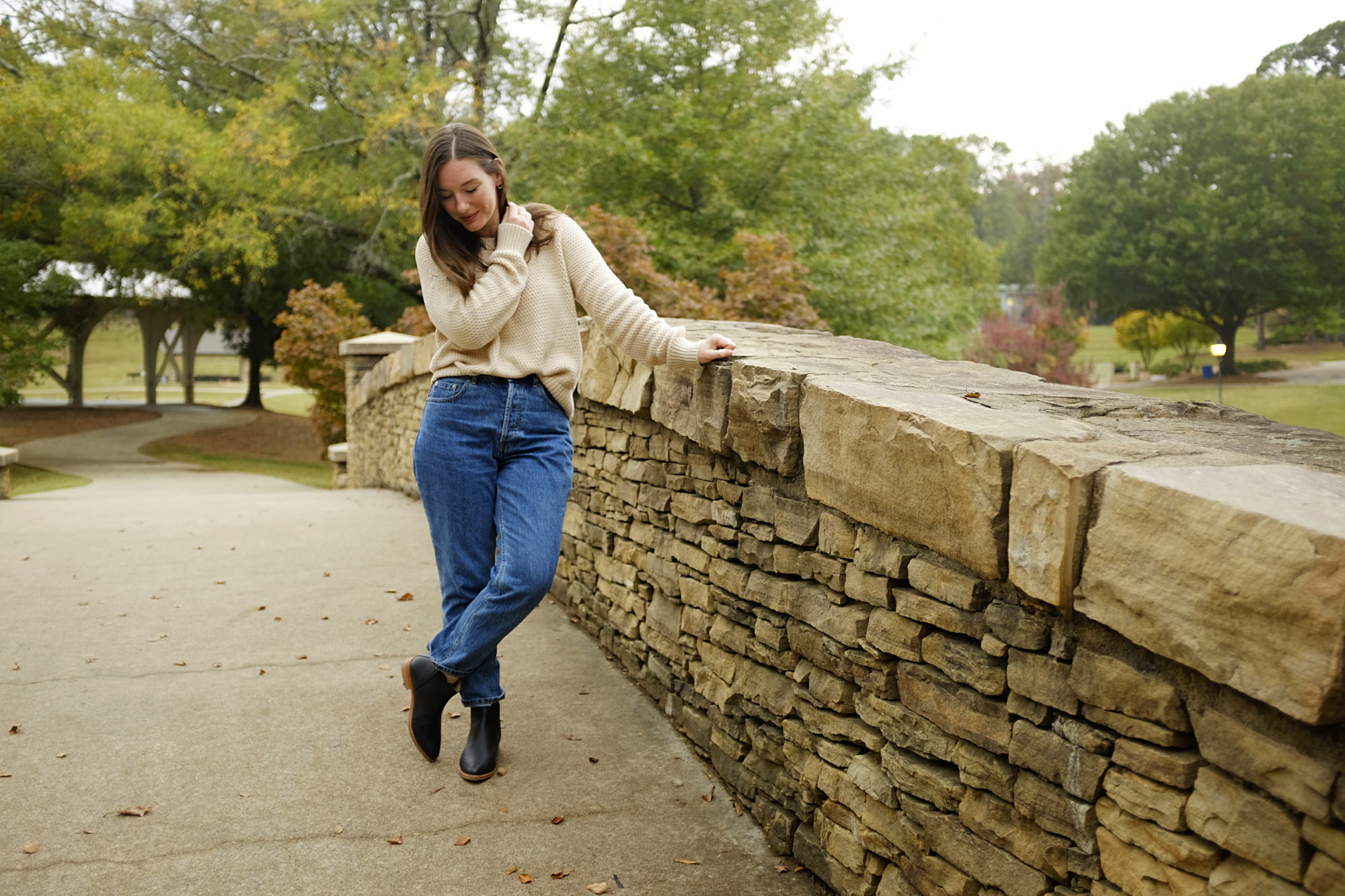 Alyssa wears the Honeycomb sweater from Pact with jeans and boots