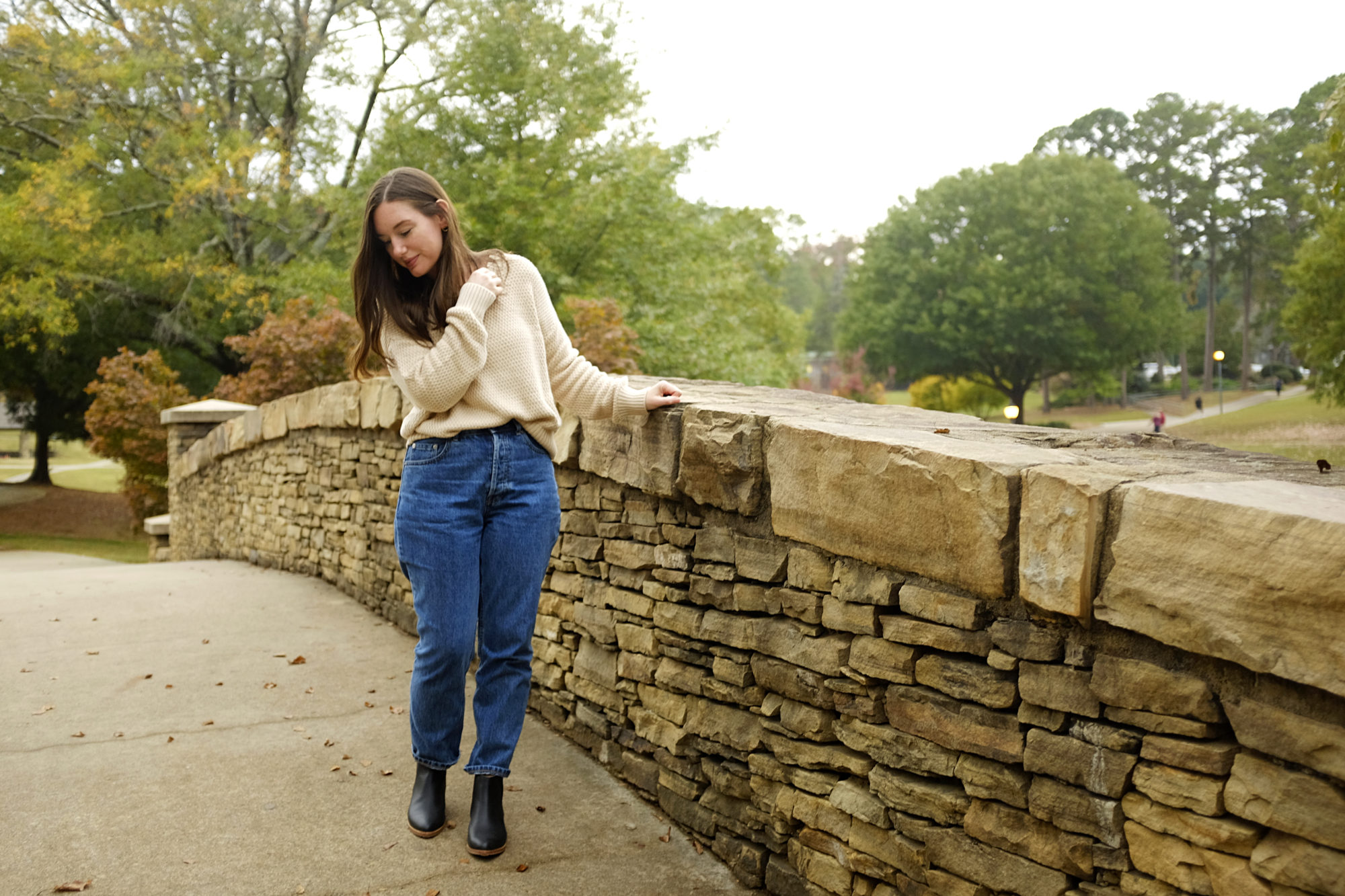 Alyssa wears the Honeycomb sweater from Pact with jeans and boots