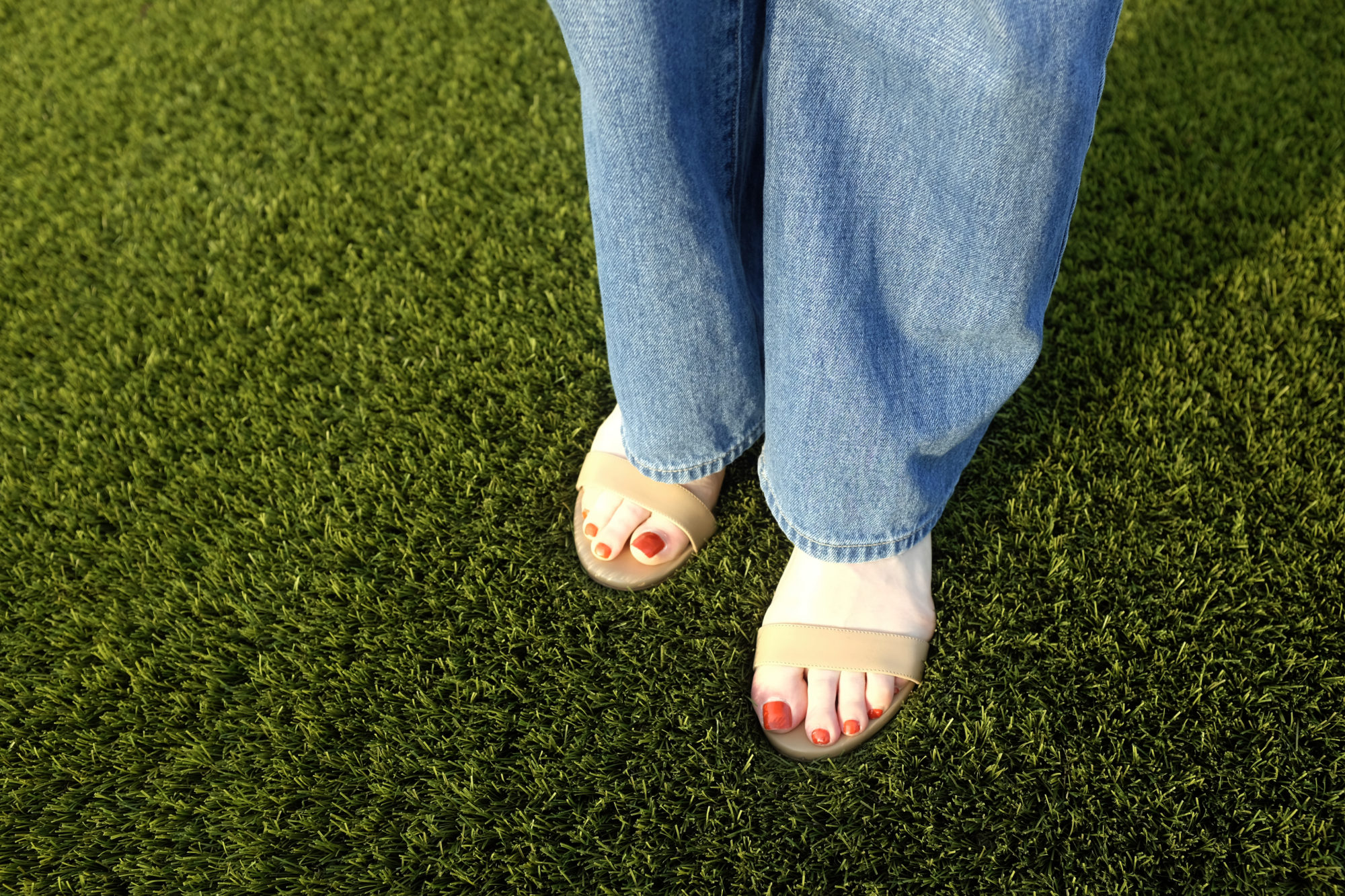 Alyssa wears the Perfect Block Sandal from Sarah Flint standing in astroturf