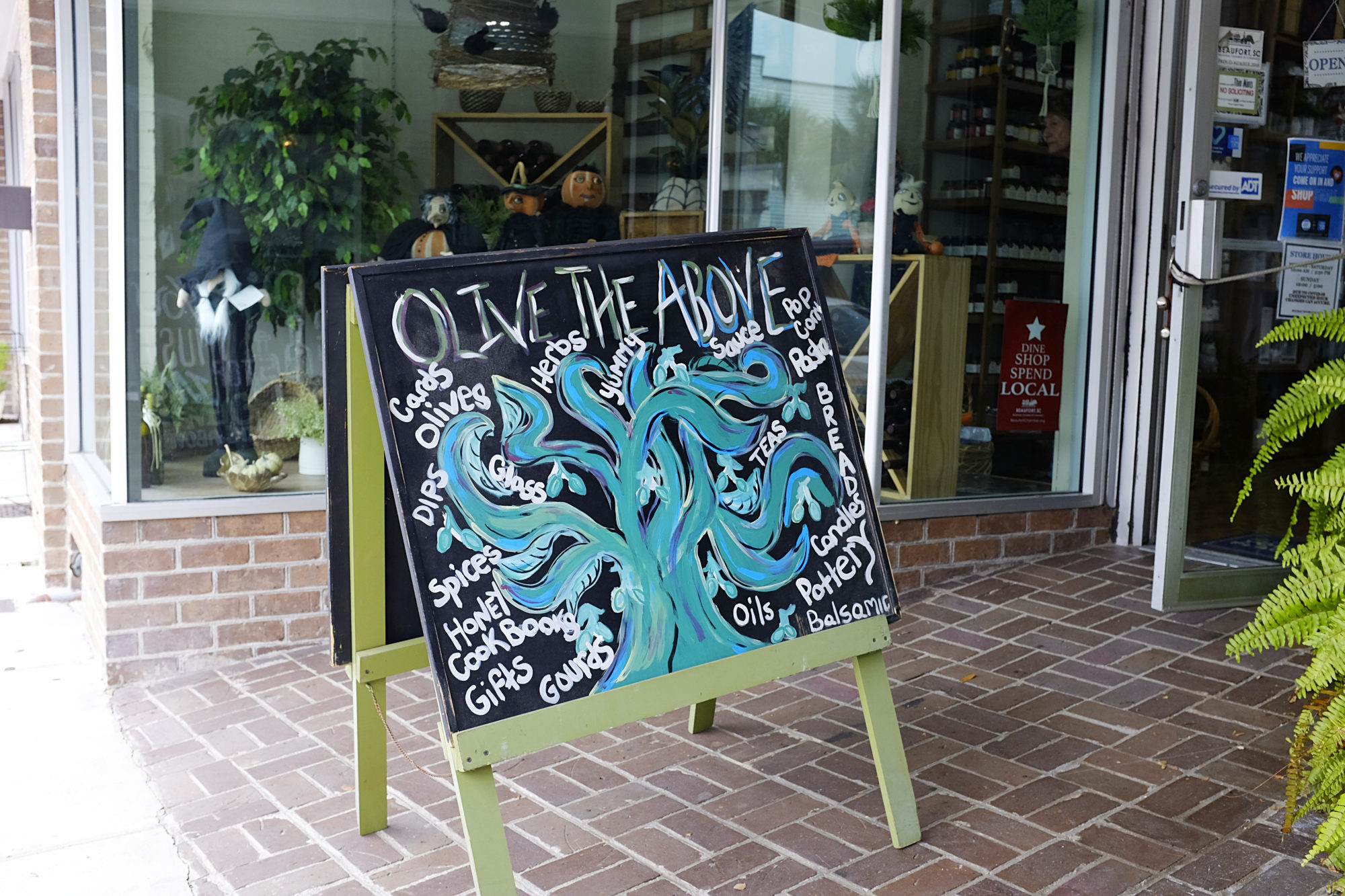 Chalkboard sign that reads "Olive the Above"