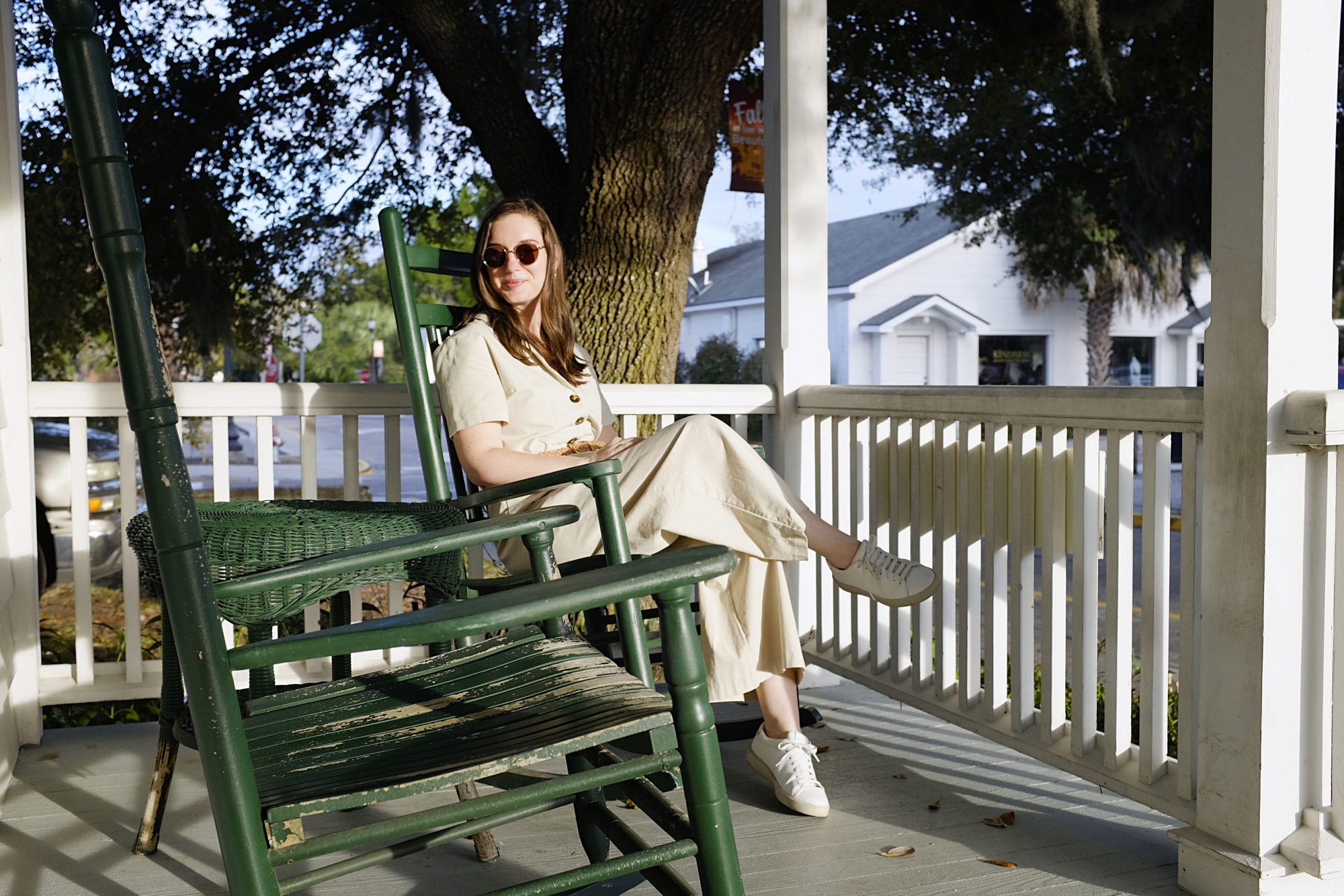 Alyssa sits on a rocking chair at The Beaufort Inn