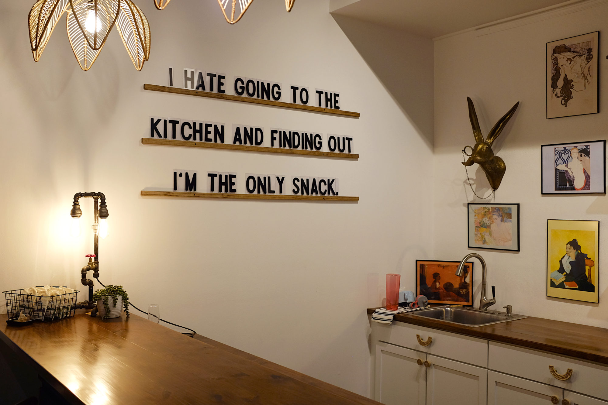 Letters on the wall that read "I hate going to the kitchen and finding out I'm the only snack"