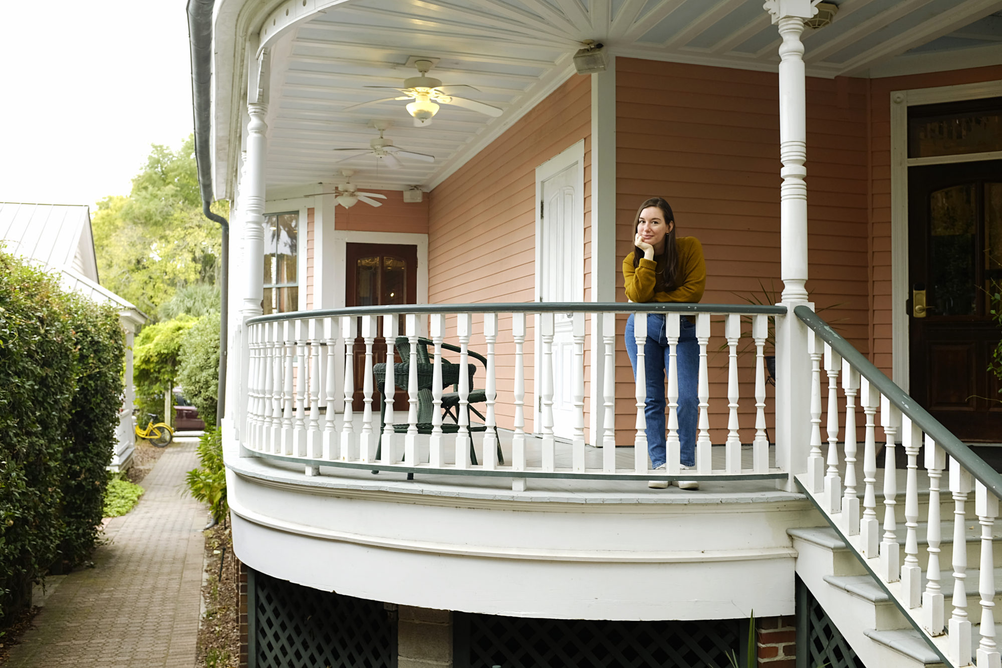 Alyssa stands on the porch at The Beaufort Inn