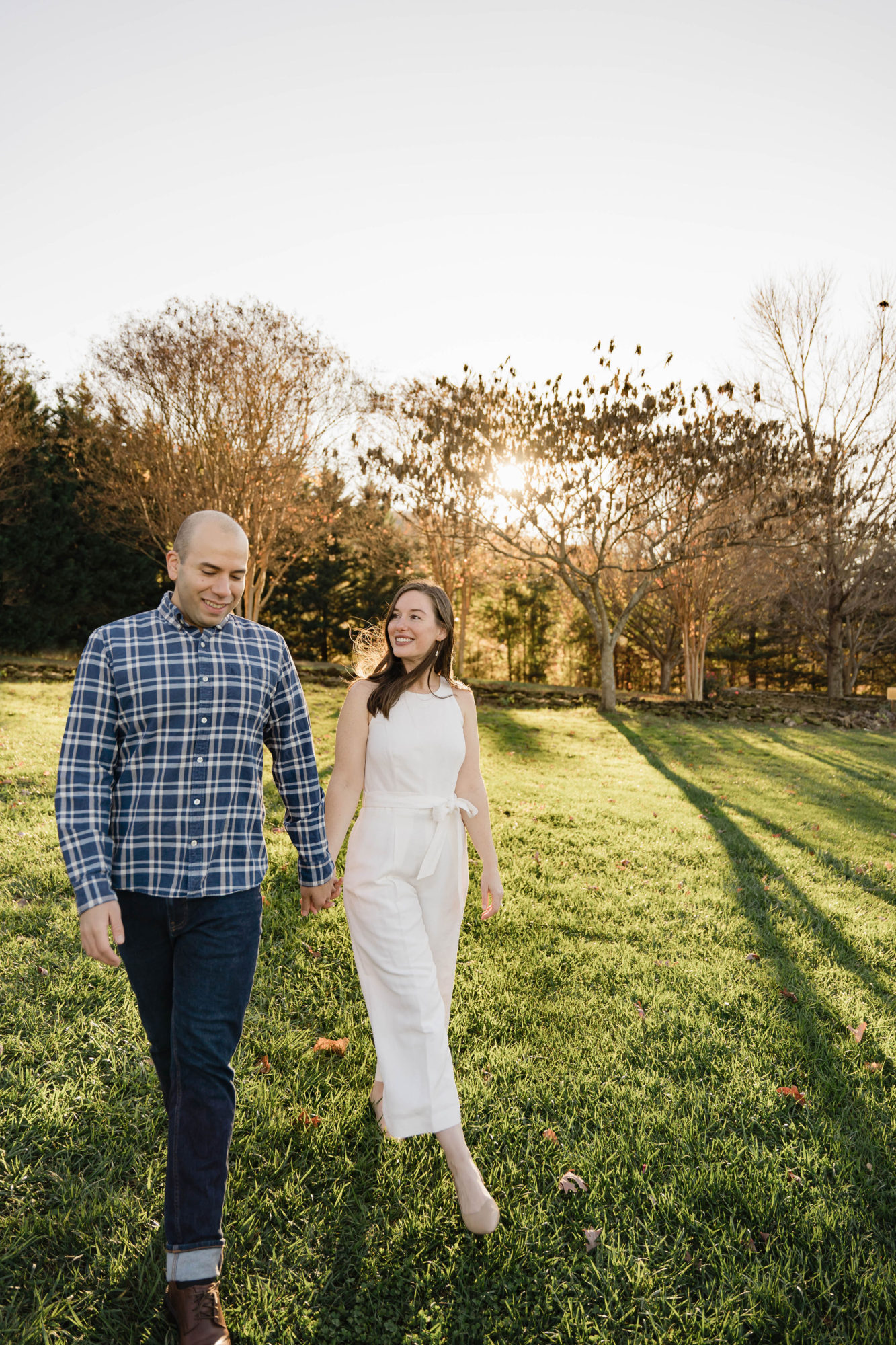 Alyssa and Michael walking in a vineyard