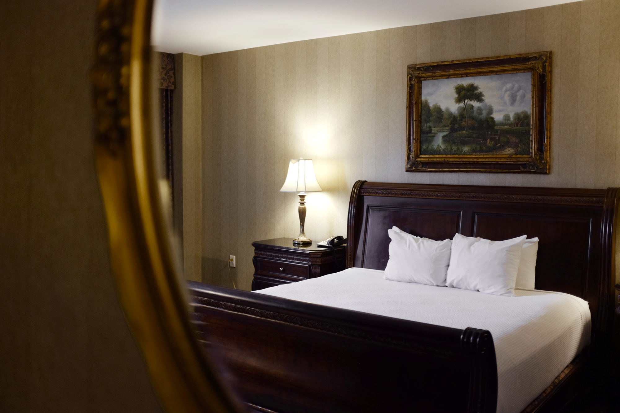 View of a sleigh bed through a mirror