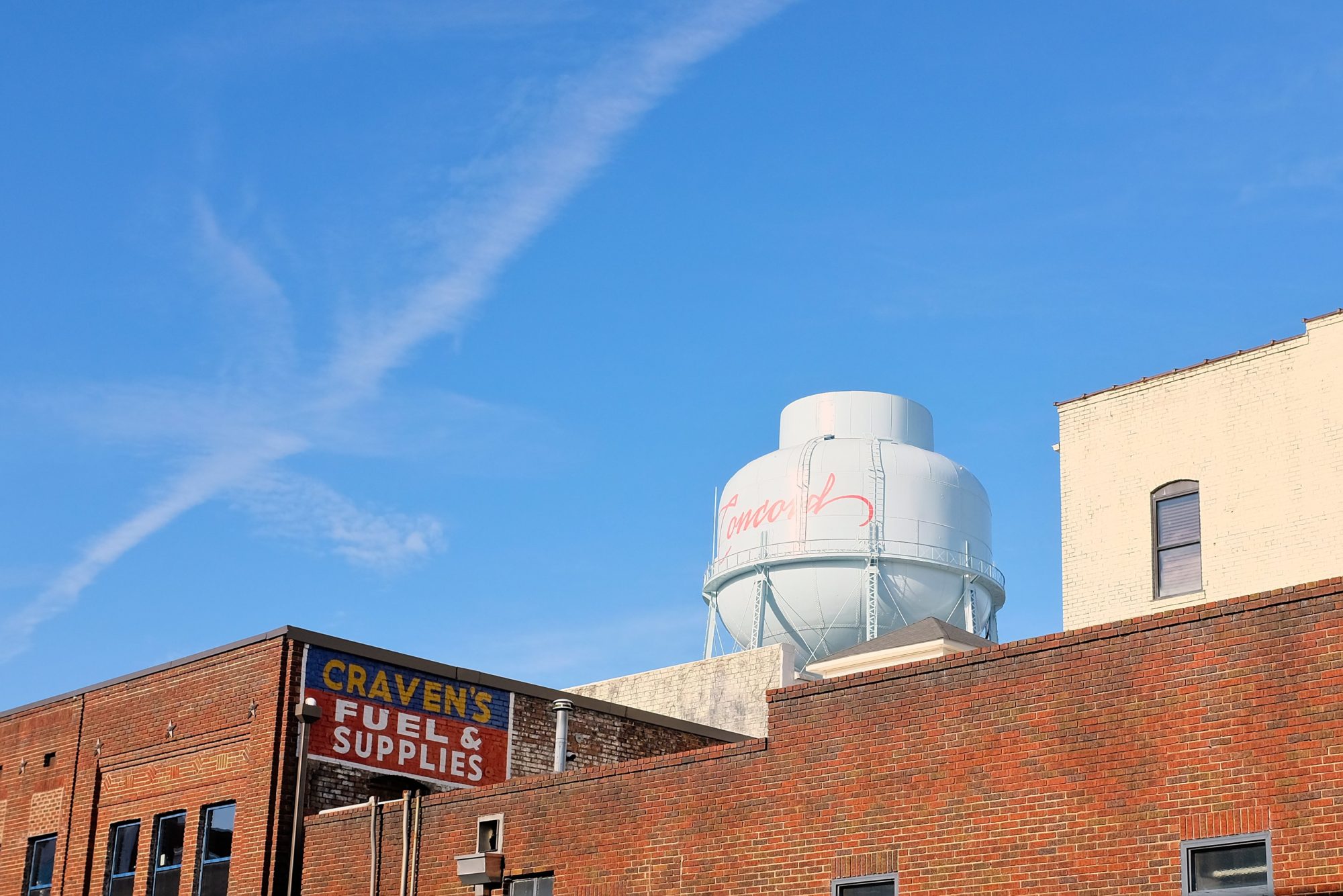 The Concord Water Tower towers over buildings in downtown Concord