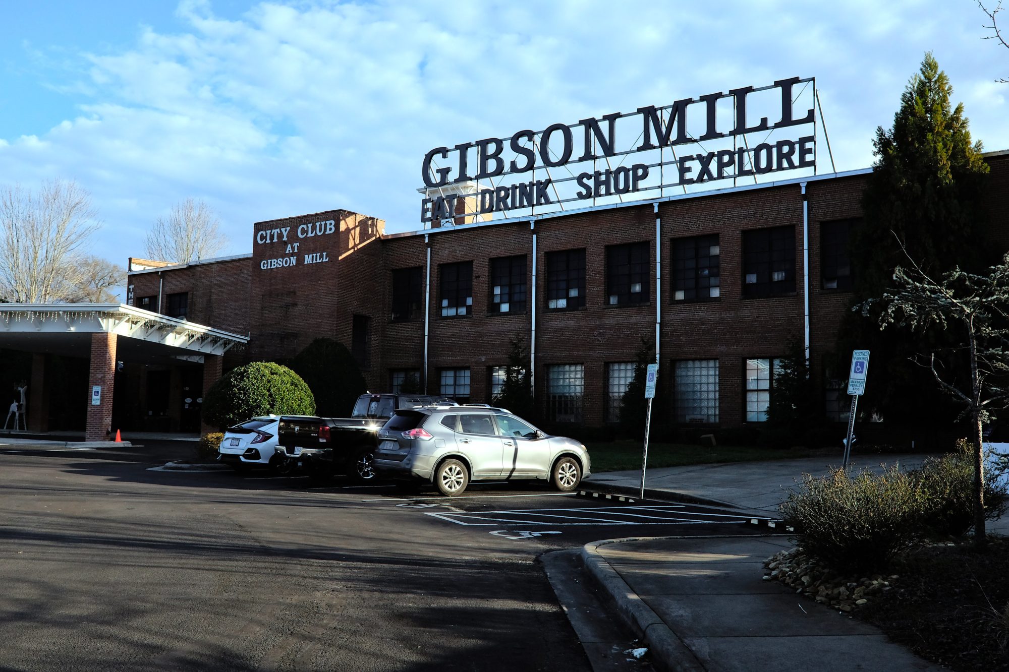 Exterior of Gibson Mill with its sign that reads "Eat Drink Shop Explore"