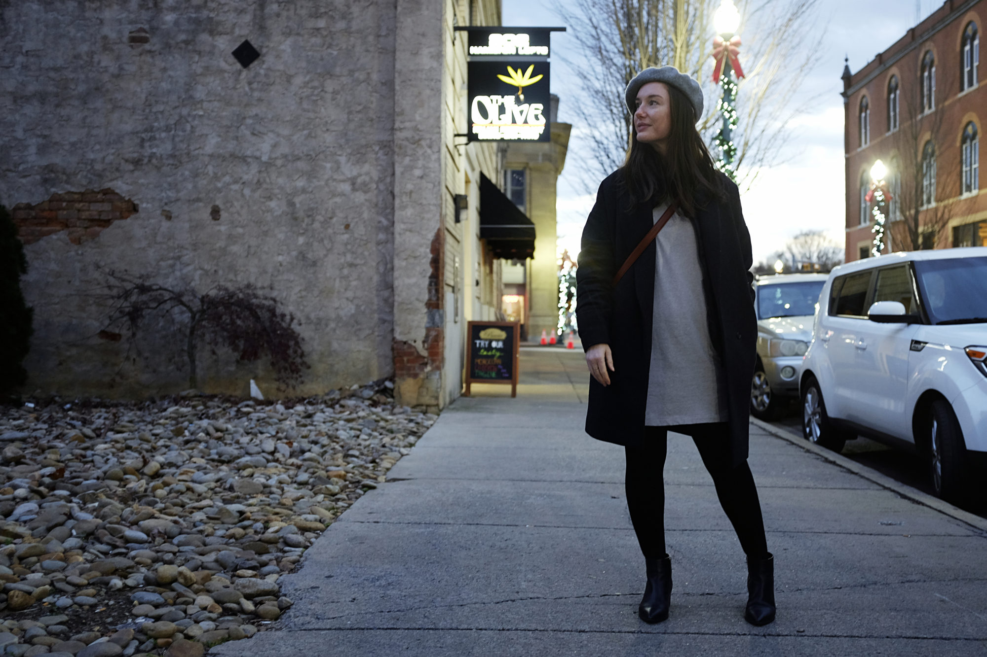 Alyssa in a sweater dress, boots, and beret