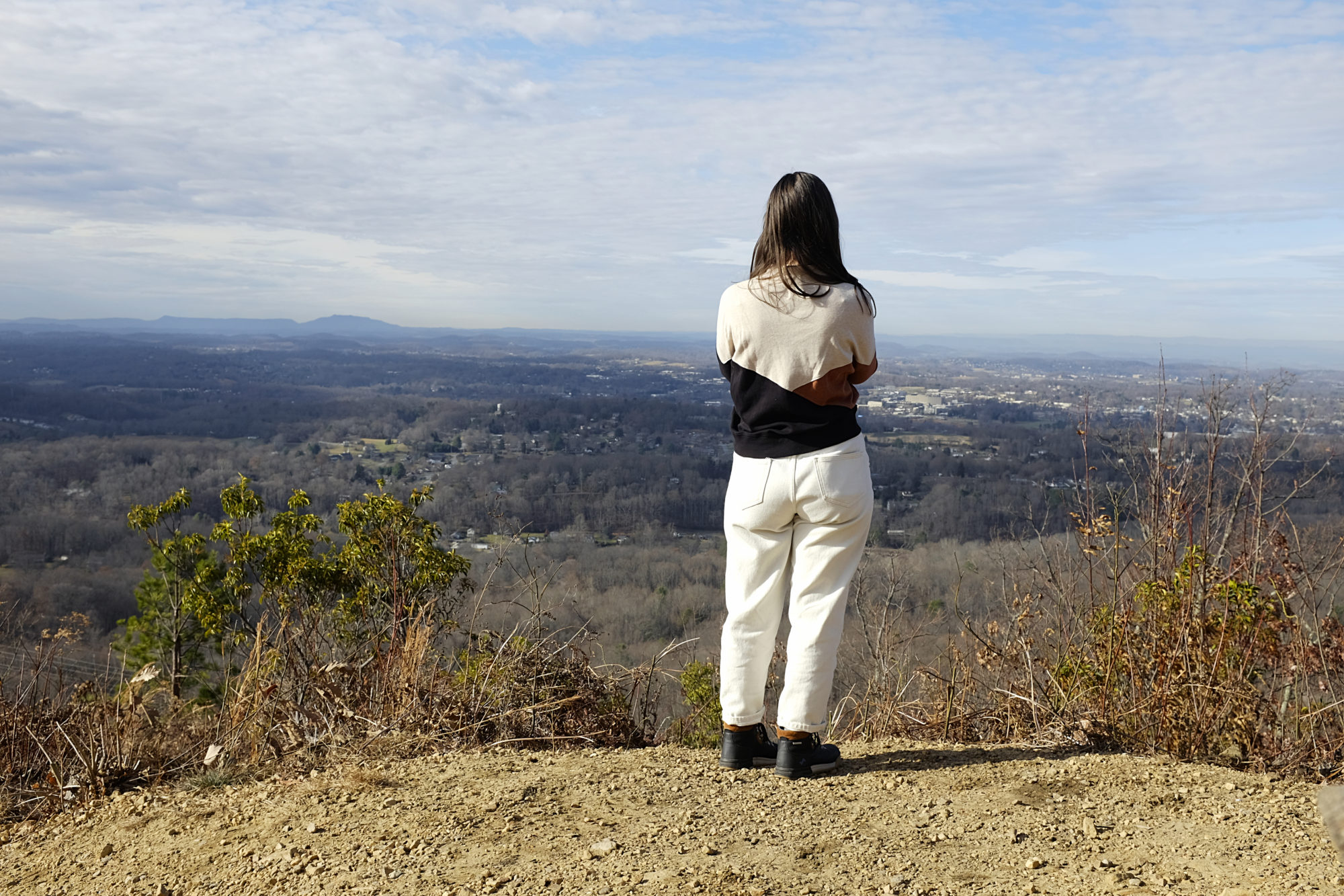 Alyssa looks out over Johnson City in her hiking clothes