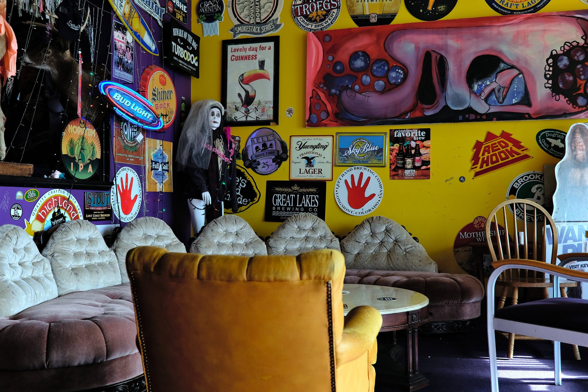 Eclectic chairs in a circle with many posters on the wall