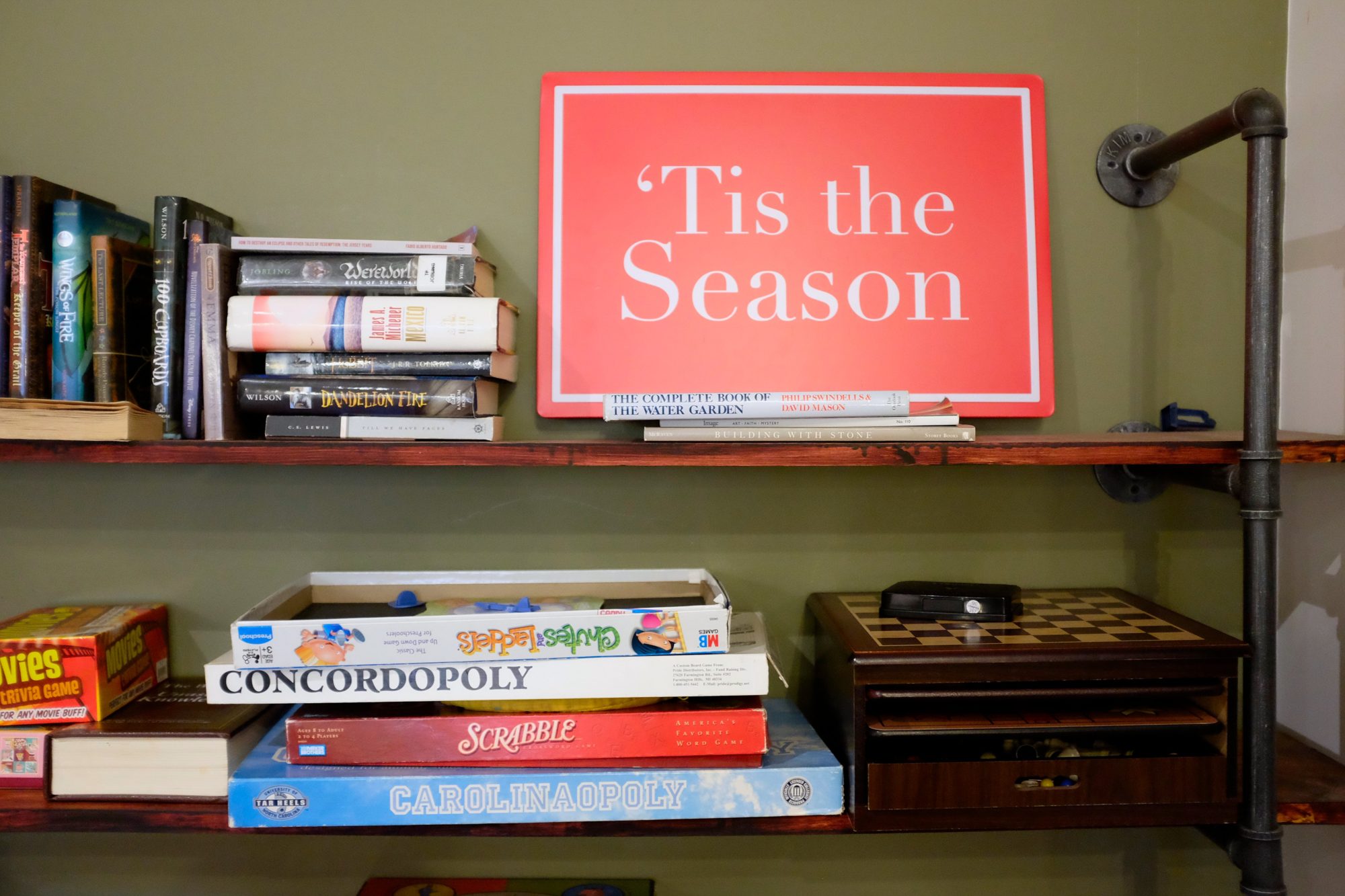 Bookshelf with games and books at Press & Porter in Concord