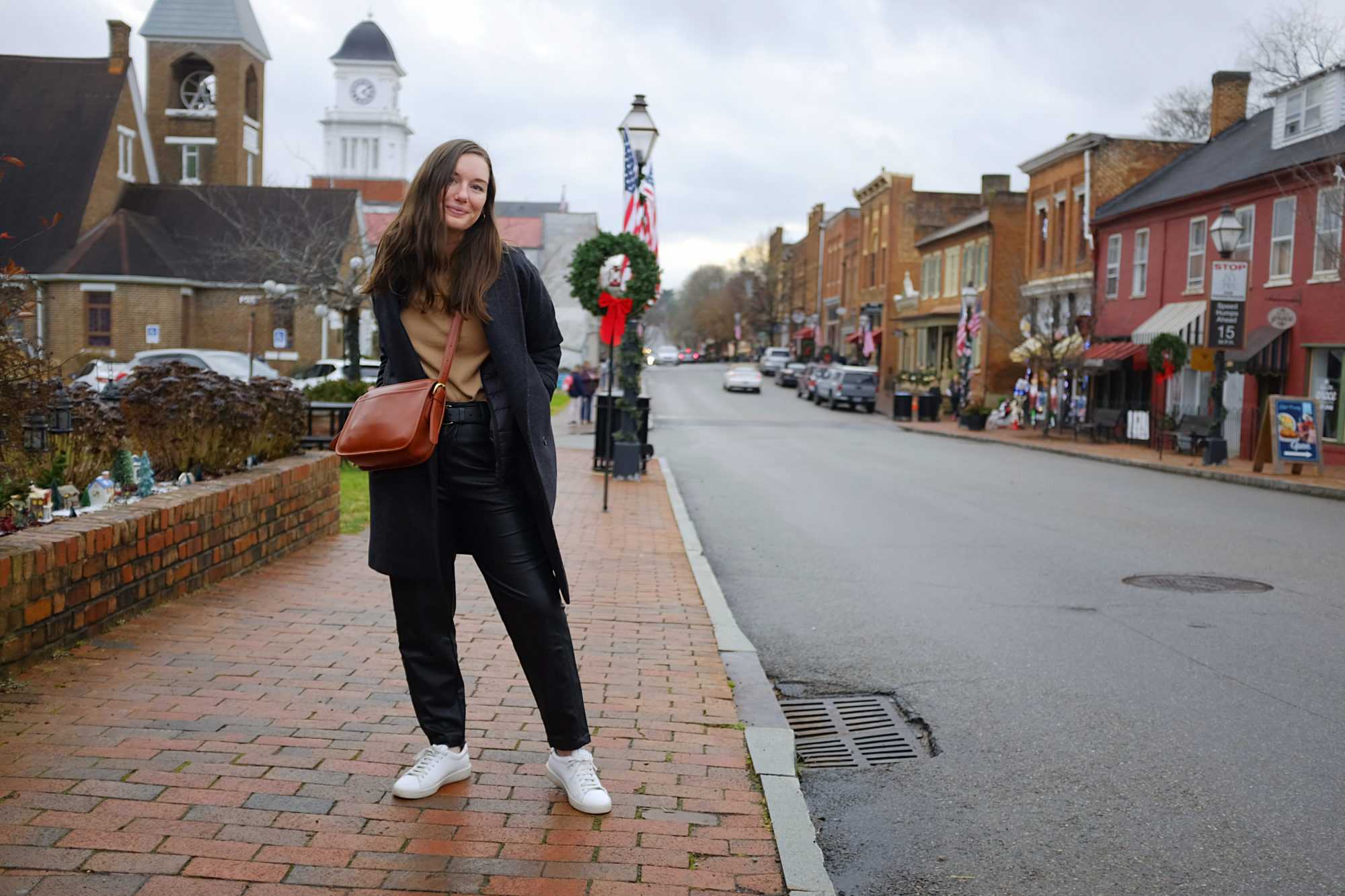 Alyssa wears a camel sweater and leather pants in Jonesborough