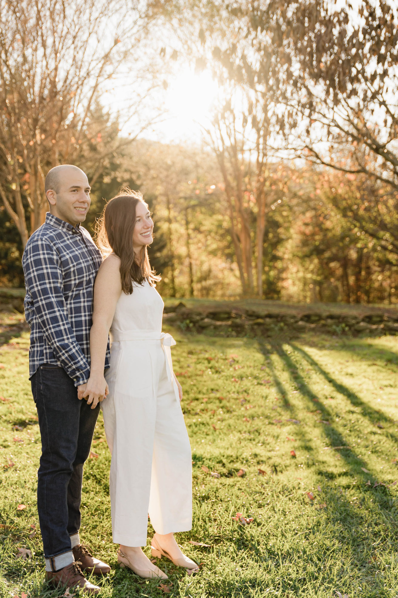 Michael holds Alyssa's hand in a vineyard