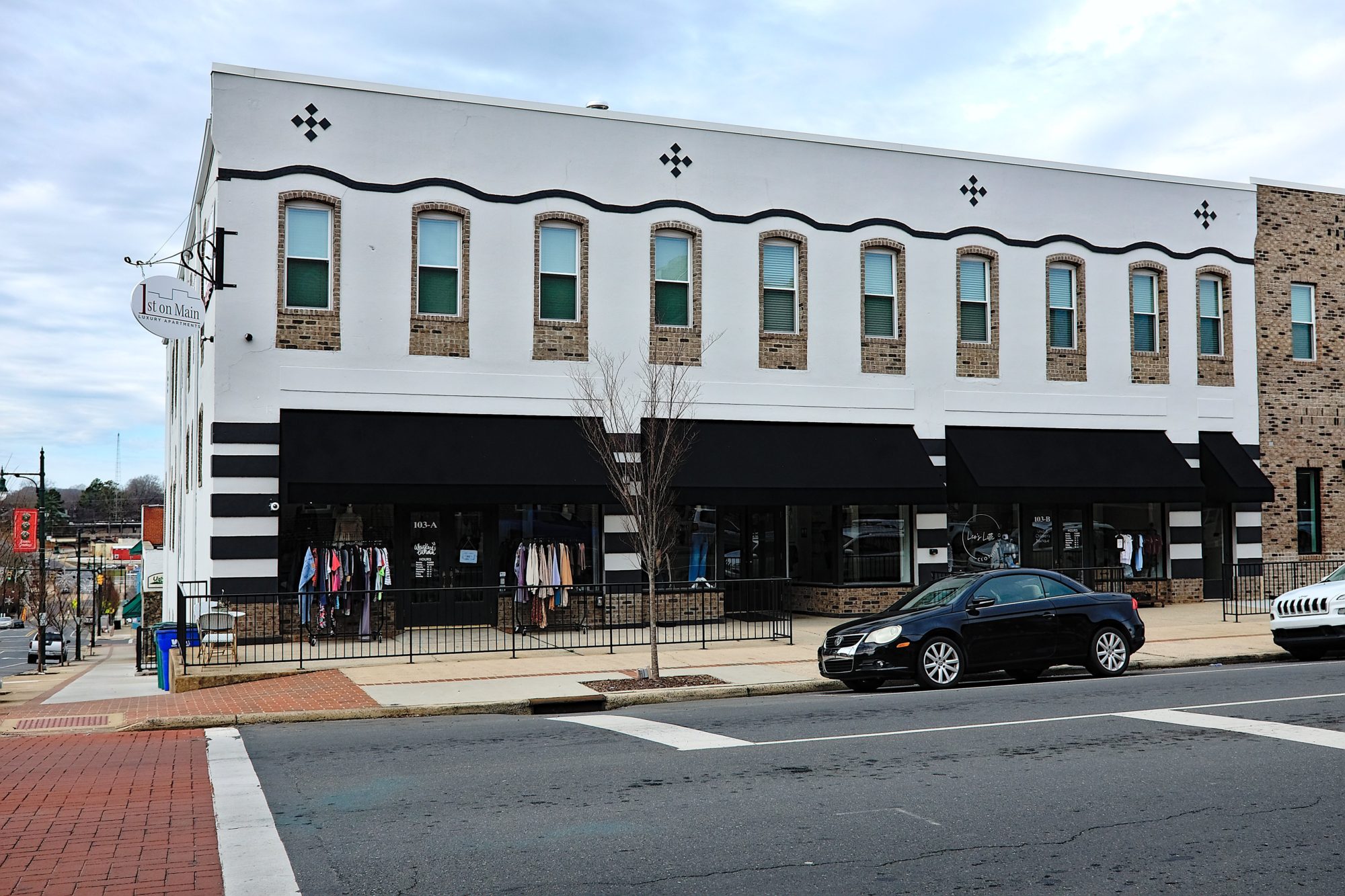Exterior of a white building containing three businesses 