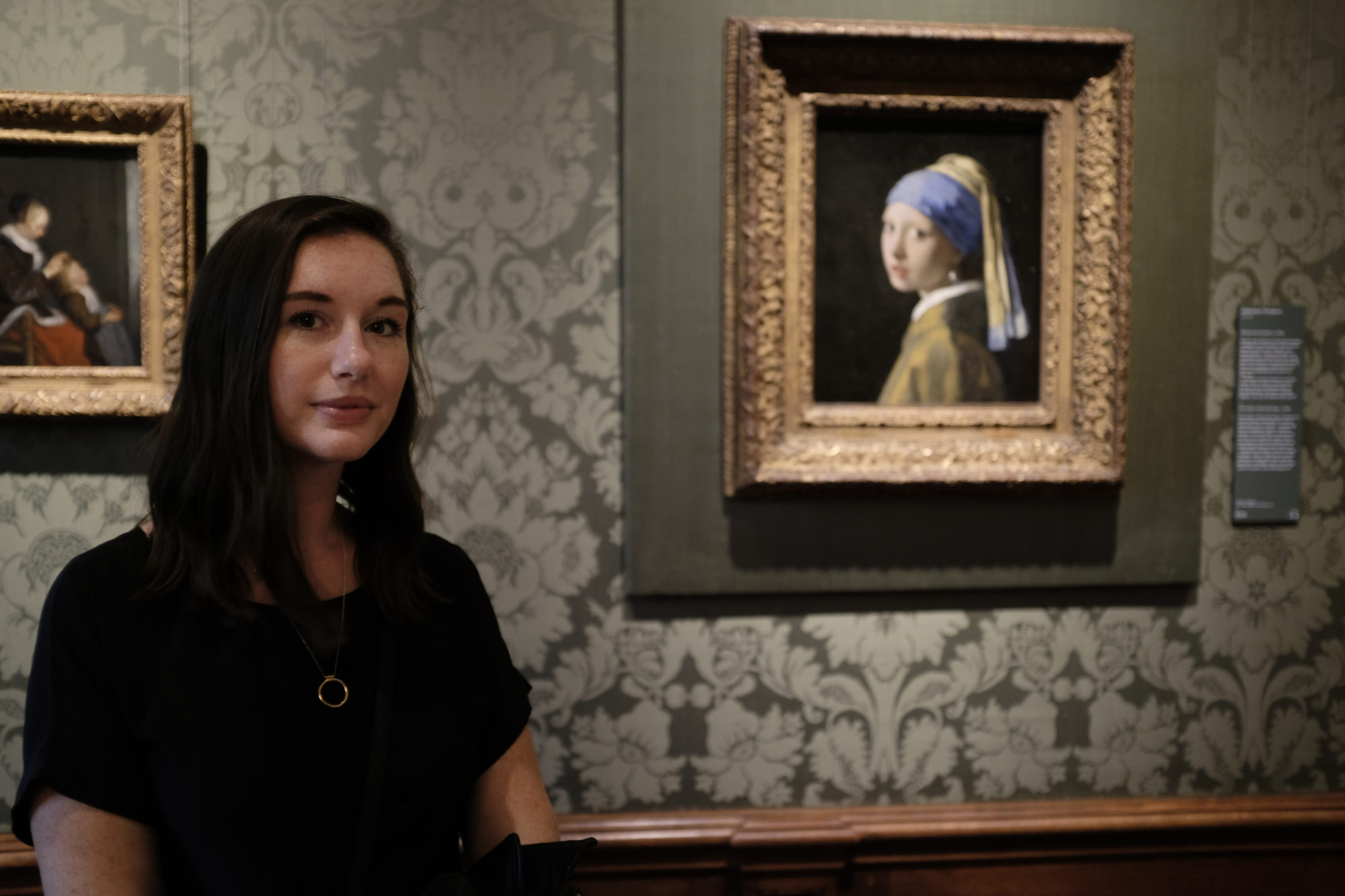 Alyssa stands next to The Girl with a Pearl Earring